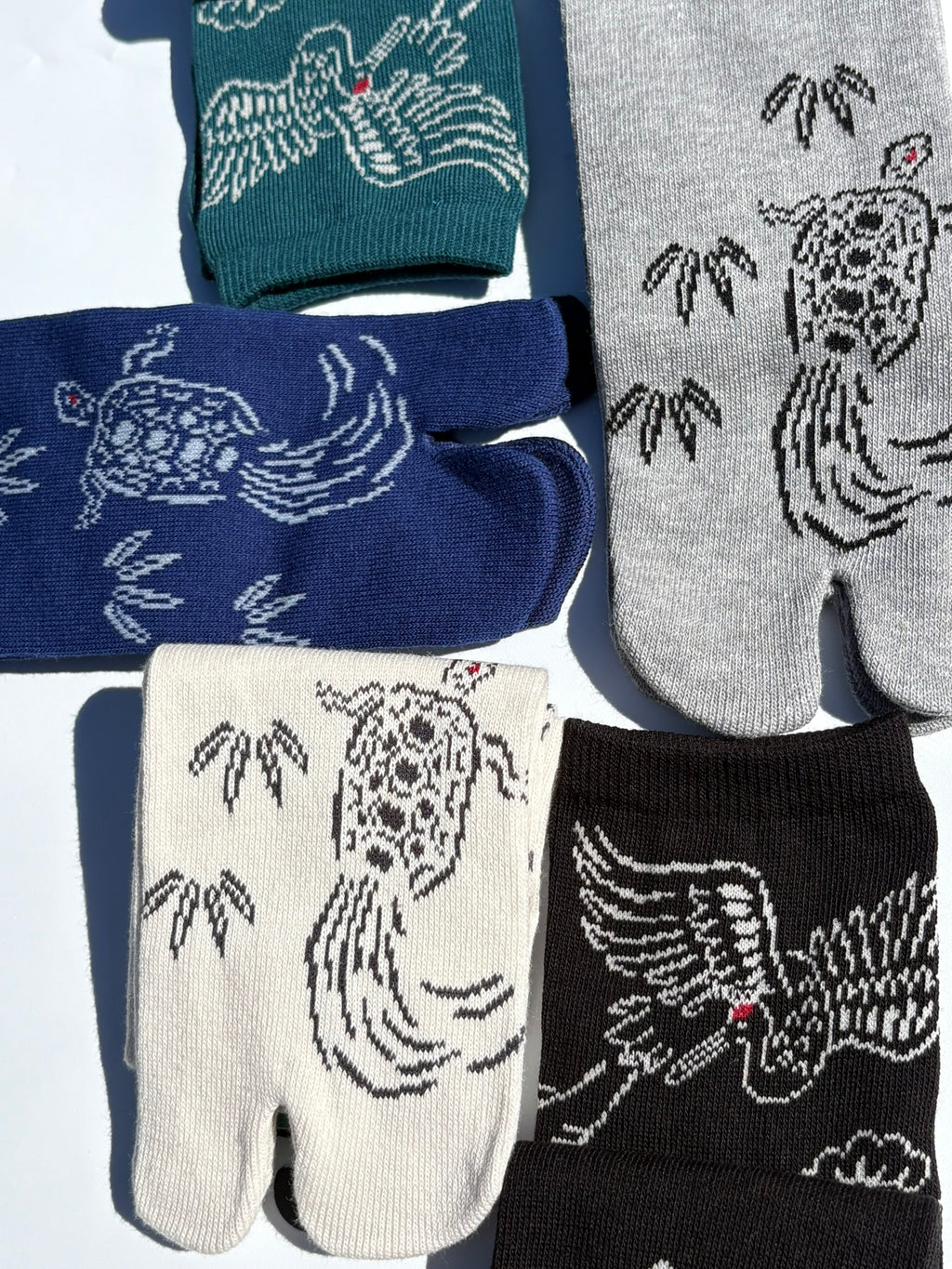 close up of graphic printed tabi socks show turtle and crane prints 