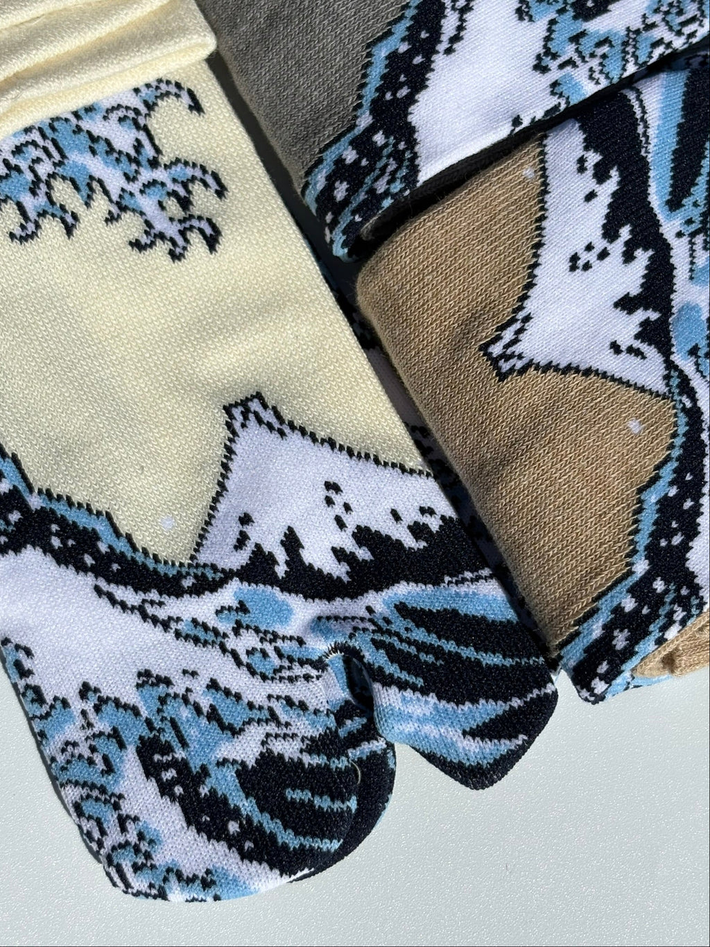 close up of tabi split-toe socks with Hokusai Great Wave off Kanagawa print — Omotenashi Selection Gold Award 2024 Japanese-made art tabi socks (足袋)