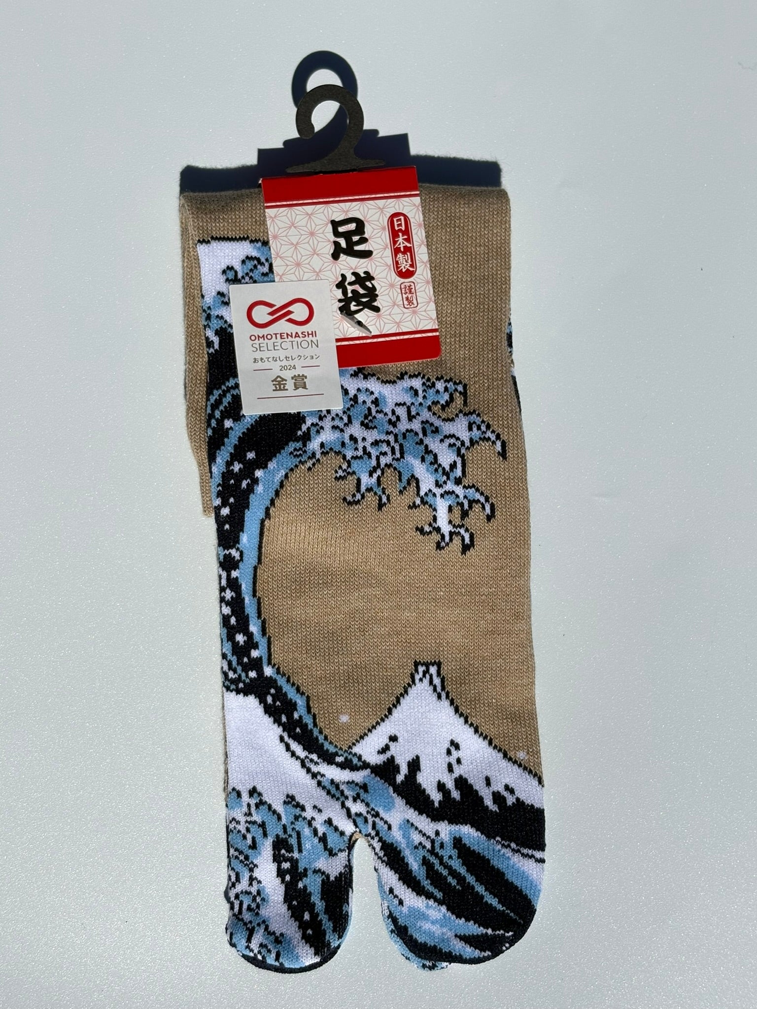 beige tabi split-toe socks with Hokusai Great Wave off Kanagawa print — Omotenashi Selection Gold Award 2024 Japanese-made art tabi socks (足袋)