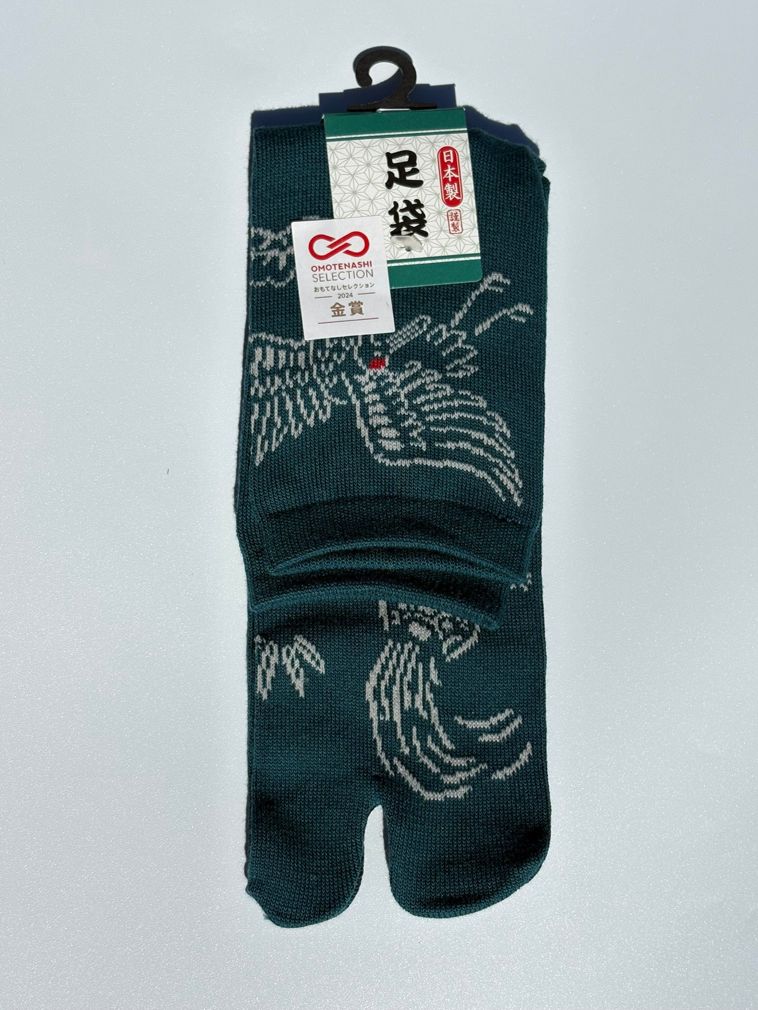 green pair of tabi japanese socks with a turtle in japanese graphic - crew length made of cotton won the omotenashi selection gold award in japan 2024
