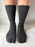 Gray tabi socks worn on a white background