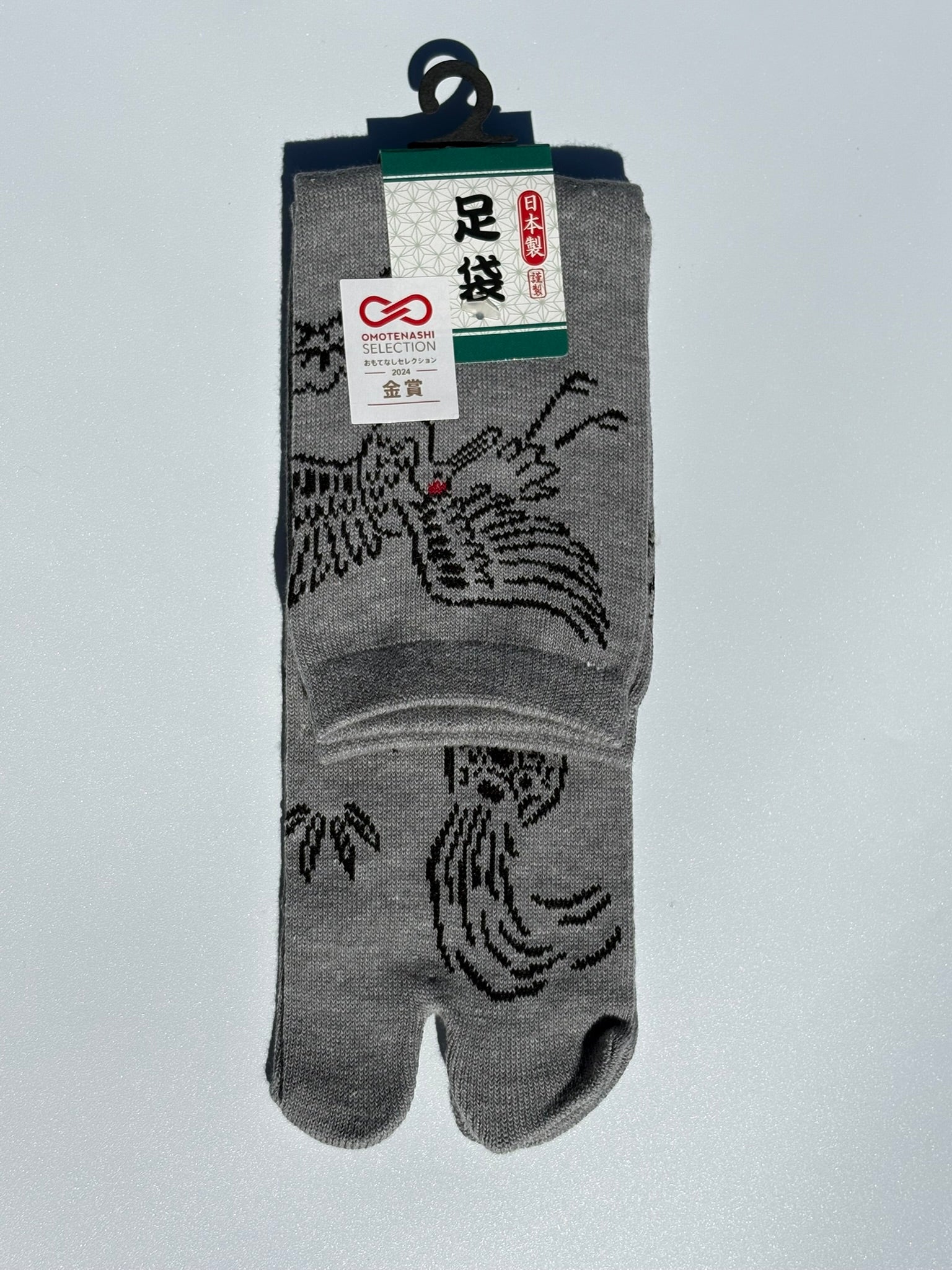 grey pair of tabi socks of a crane and turtle in japanese graphic - crew length made of cotton won the omotenashi selection gold award in japan 2024