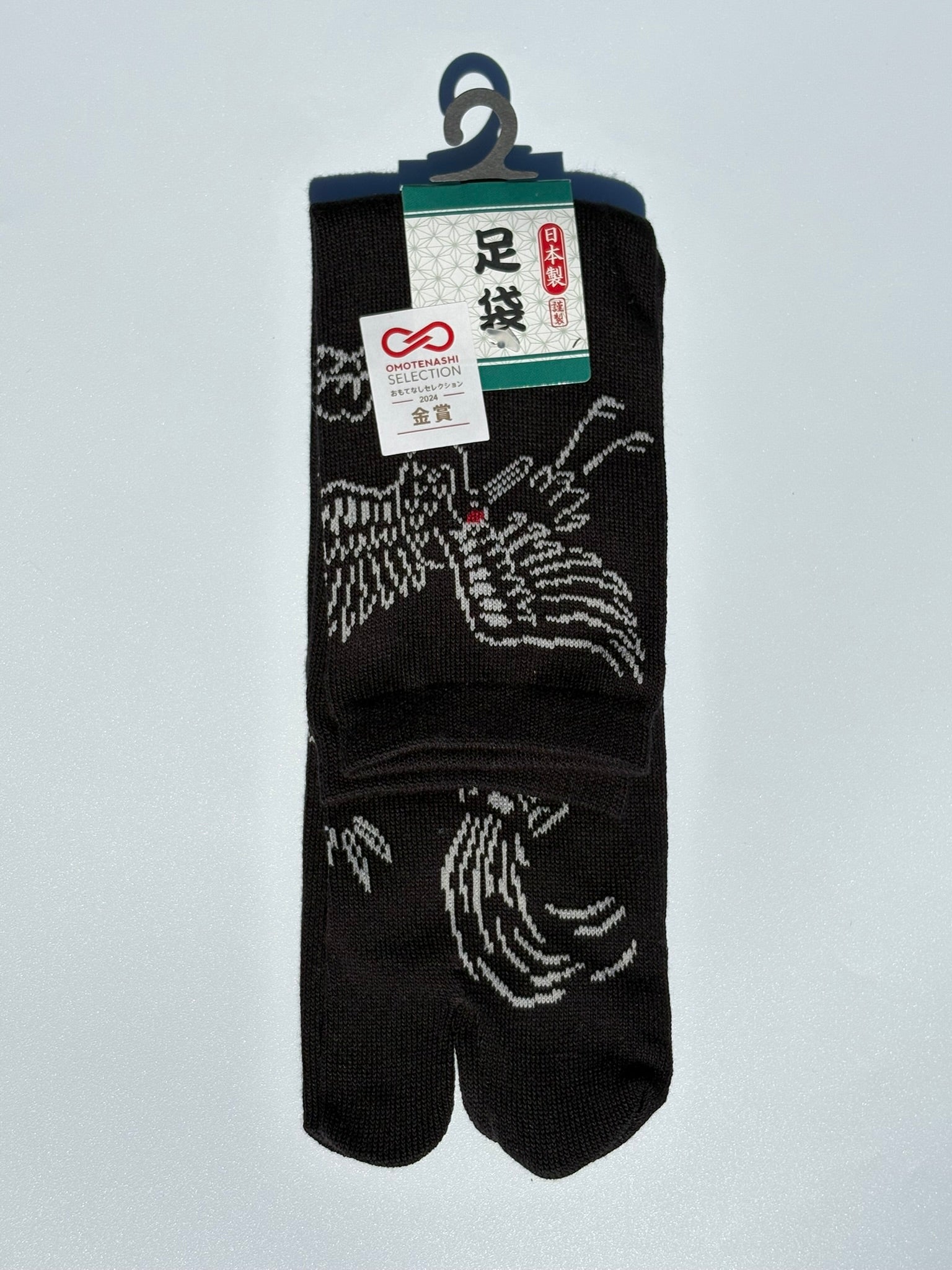 Black pair of tabi socks of a crane and turtle in japanese graphic - crew length made of cotton won the omotenashi selection gold award in japan 2024