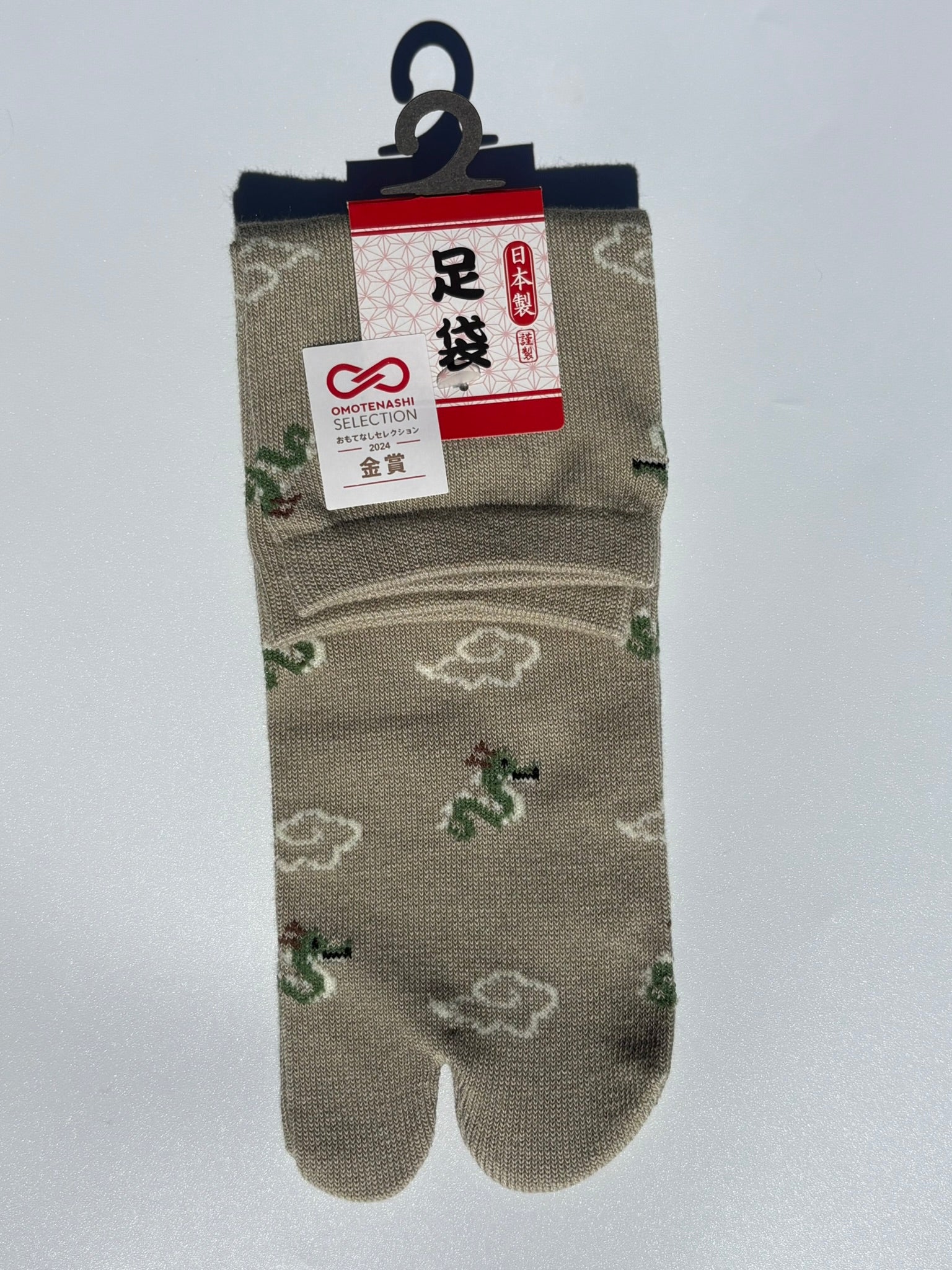 sage pair of beige dragon and clouds print tabi socks made in japan premium cotton quality lay flat on white background