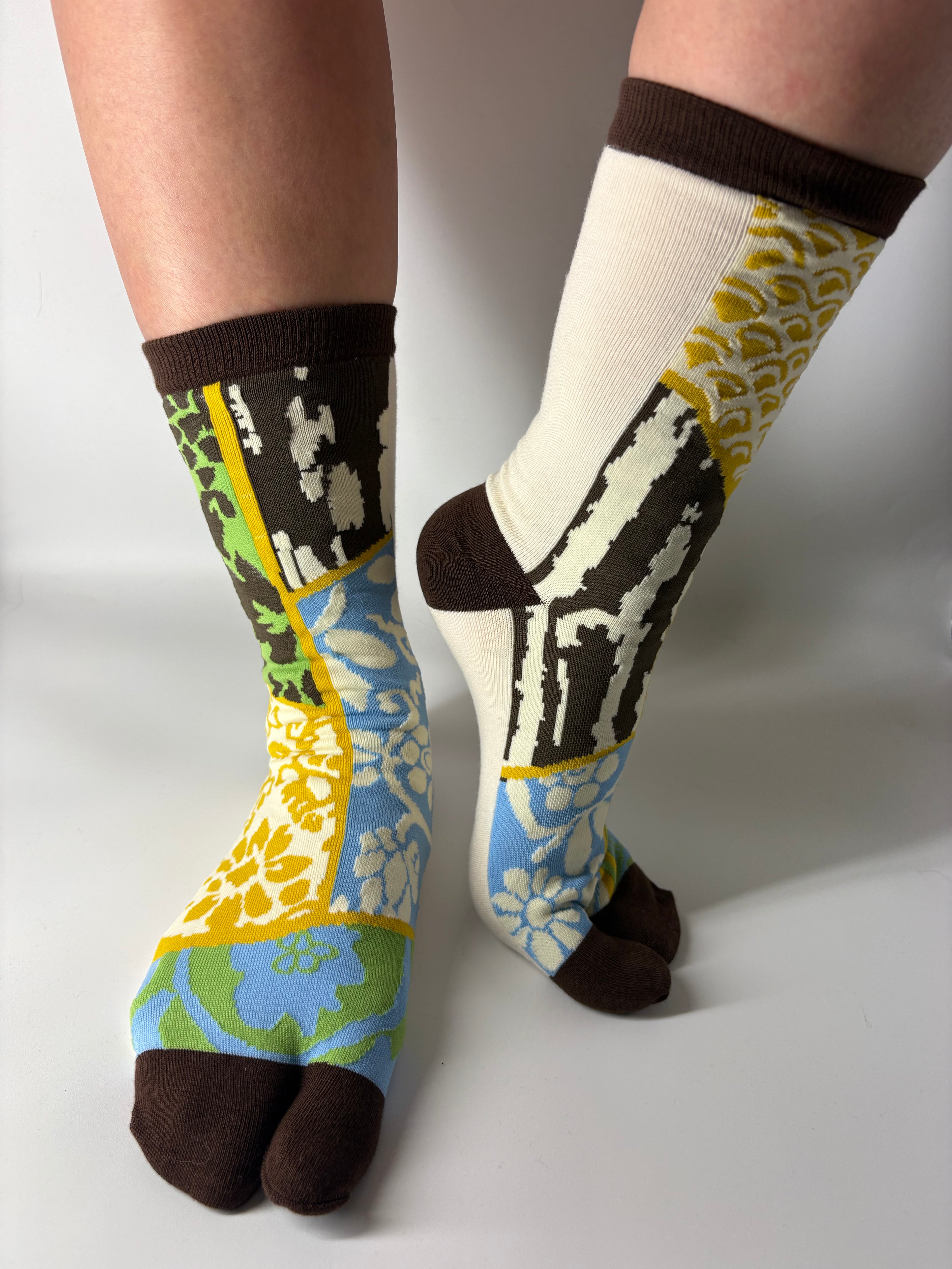 Colorful patterned socks worn on a white background