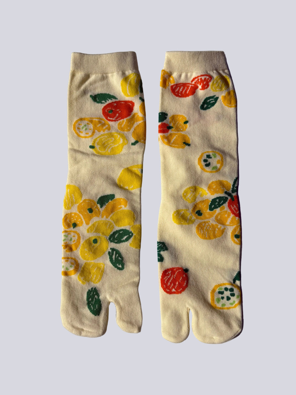 Pair of white citrus lemon print tabi socks illustration on a light gray background made of cotton material made for wearing tabi shoes
