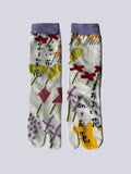 White tabi split-toe socks with pastel abstract floral print in different shades of green red lilac and yellow and purple, purple cuff — Japanese patterned tabi socks
