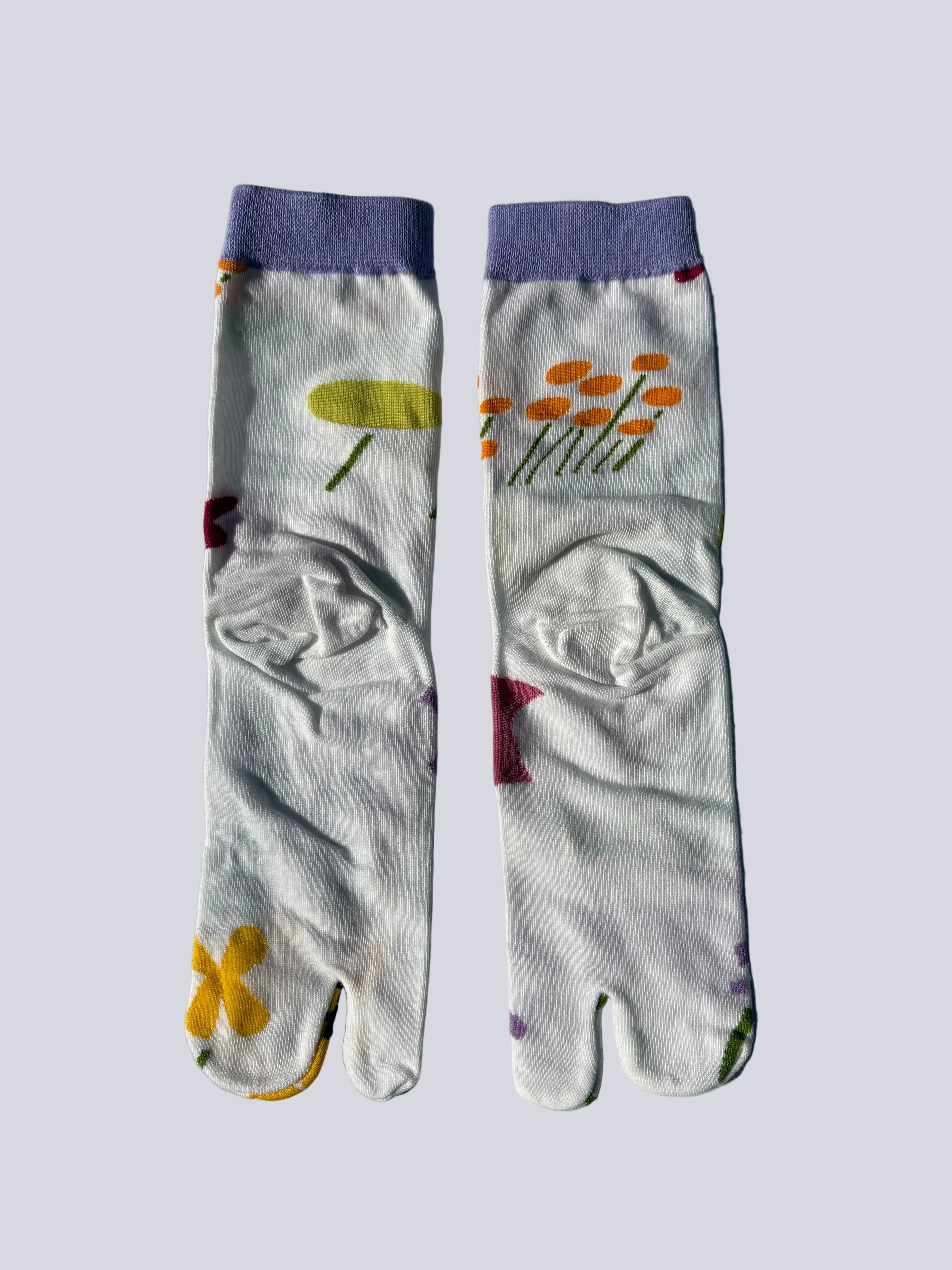 back of white tabi socks lay flat on white background