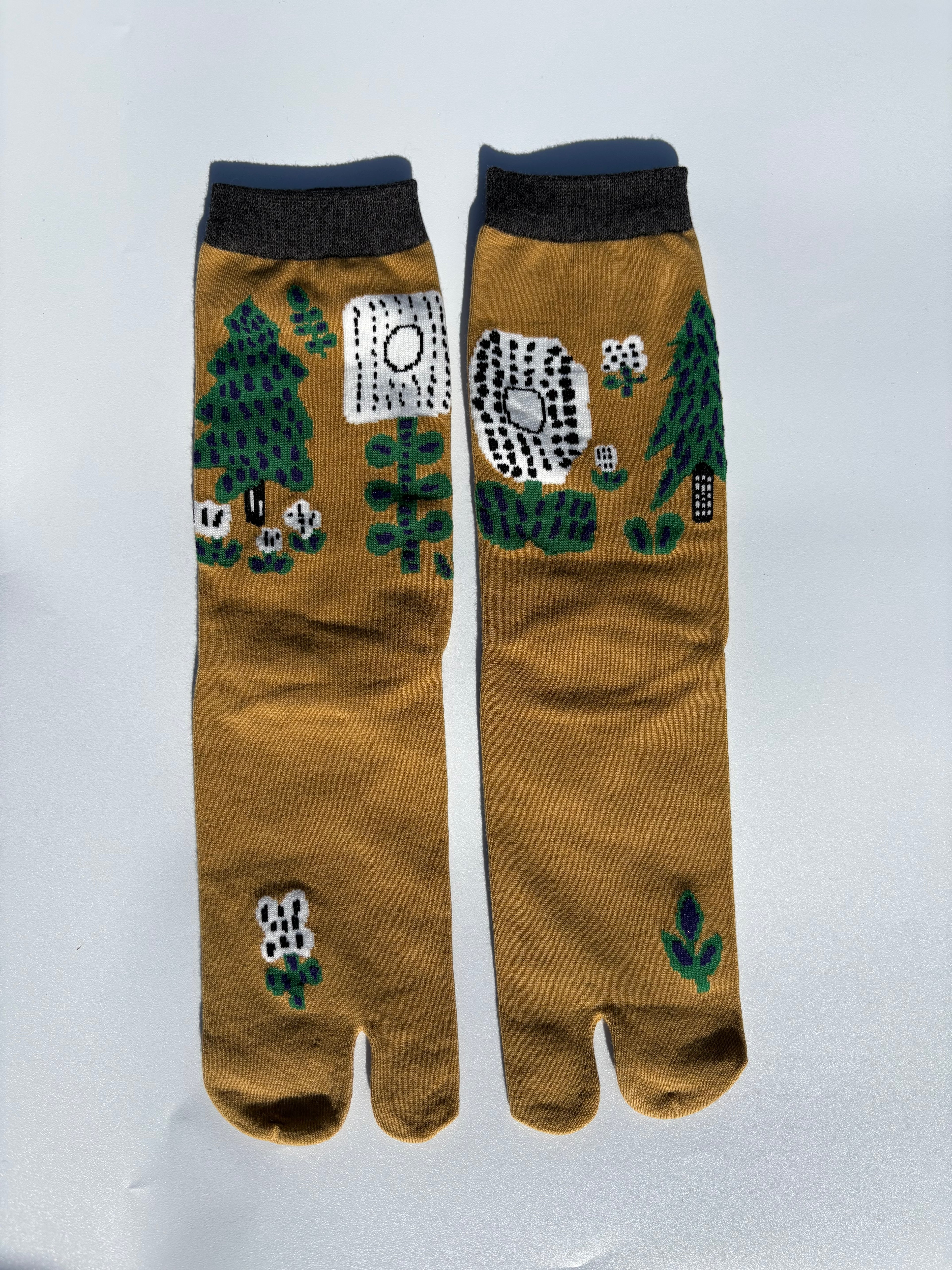Mustard yellow tabi split-toe socks with illustrated forest cabin and woodland scene print, charcoal cuff — Japanese novelty nature tabi socks made of cotton