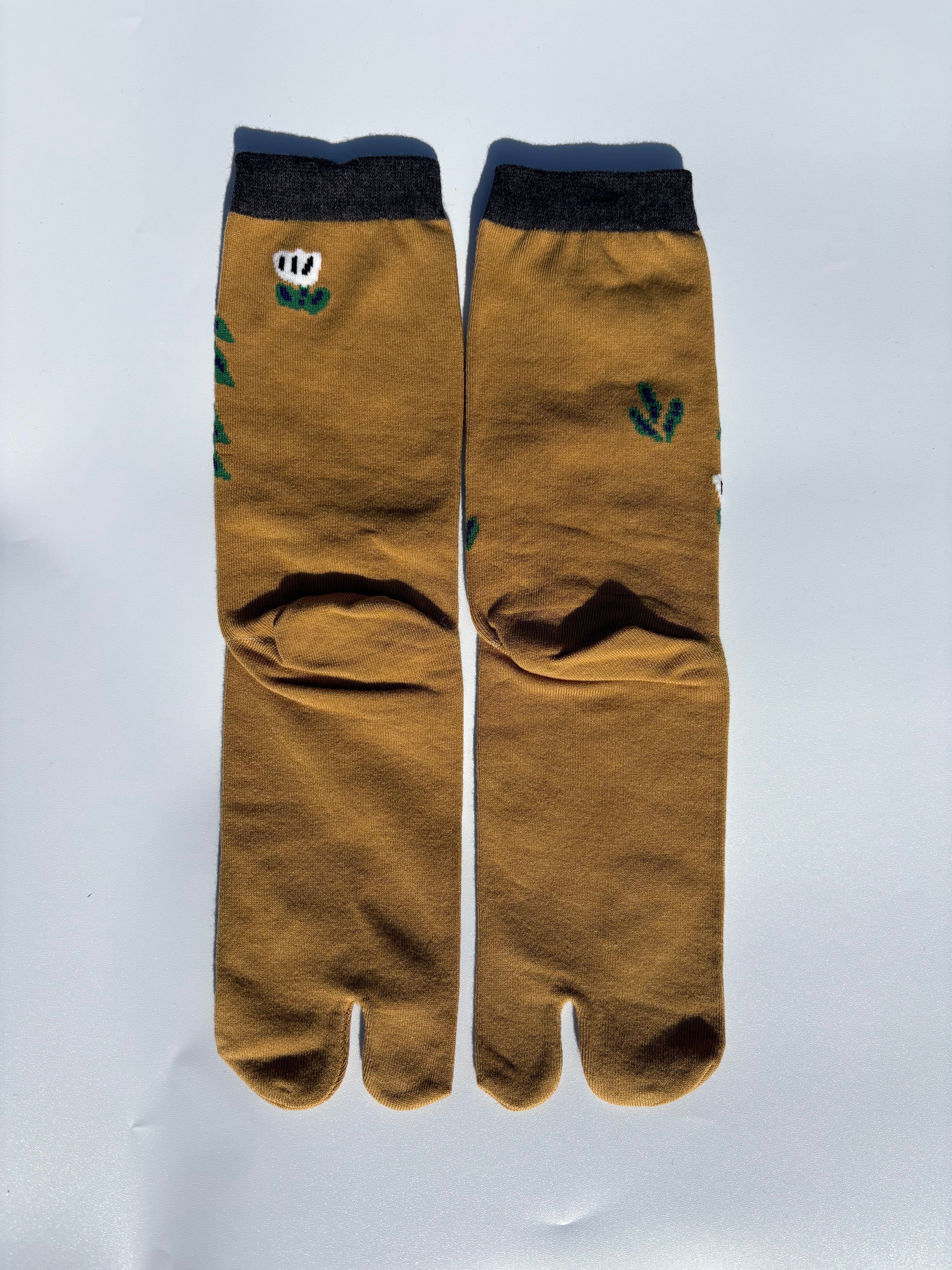 back of Mustard yellow tabi split-toe socks with illustrated forest cabin and woodland scene print, charcoal cuff — Japanese novelty nature tabi socks