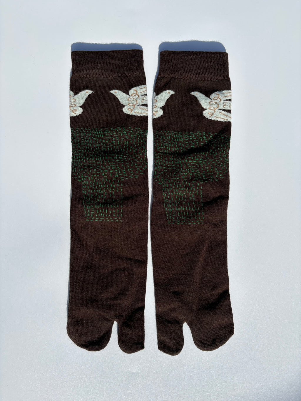 Pair of brown white dove birds print tabi socks flying over a brown field on a light gray background made of cotton material made for wearing tabi shoes