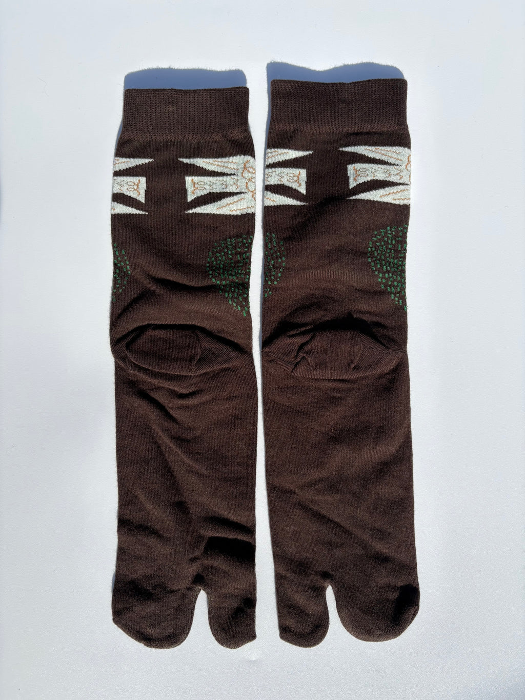 back of Pair of brown white dove birds print tabi socks flying over a brown field on a light gray background made of cotton material made for wearing tabi shoes
