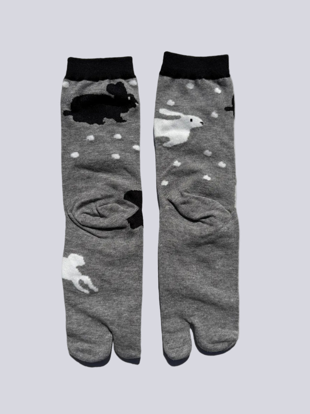 back of grey tabi socks with rabbit print on - japanese split toe design made of cotton - flat lay on white background