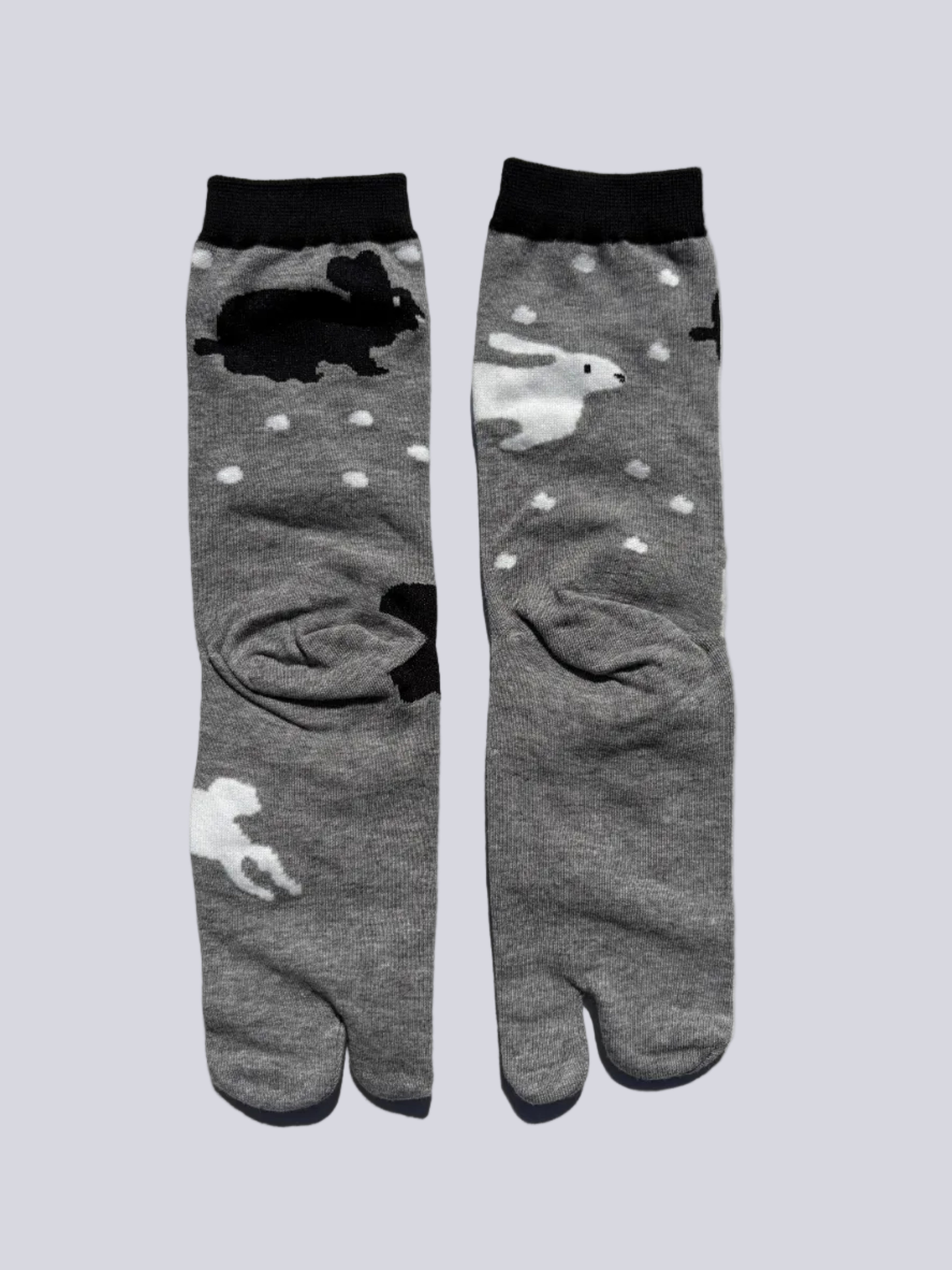 back of grey tabi socks with rabbit print on - japanese split toe design made of cotton - flat lay on white background