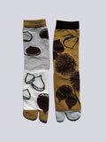 front of tan and white chestnut print tabi socks - japanese split toe design made of cotton - flat lay on white background