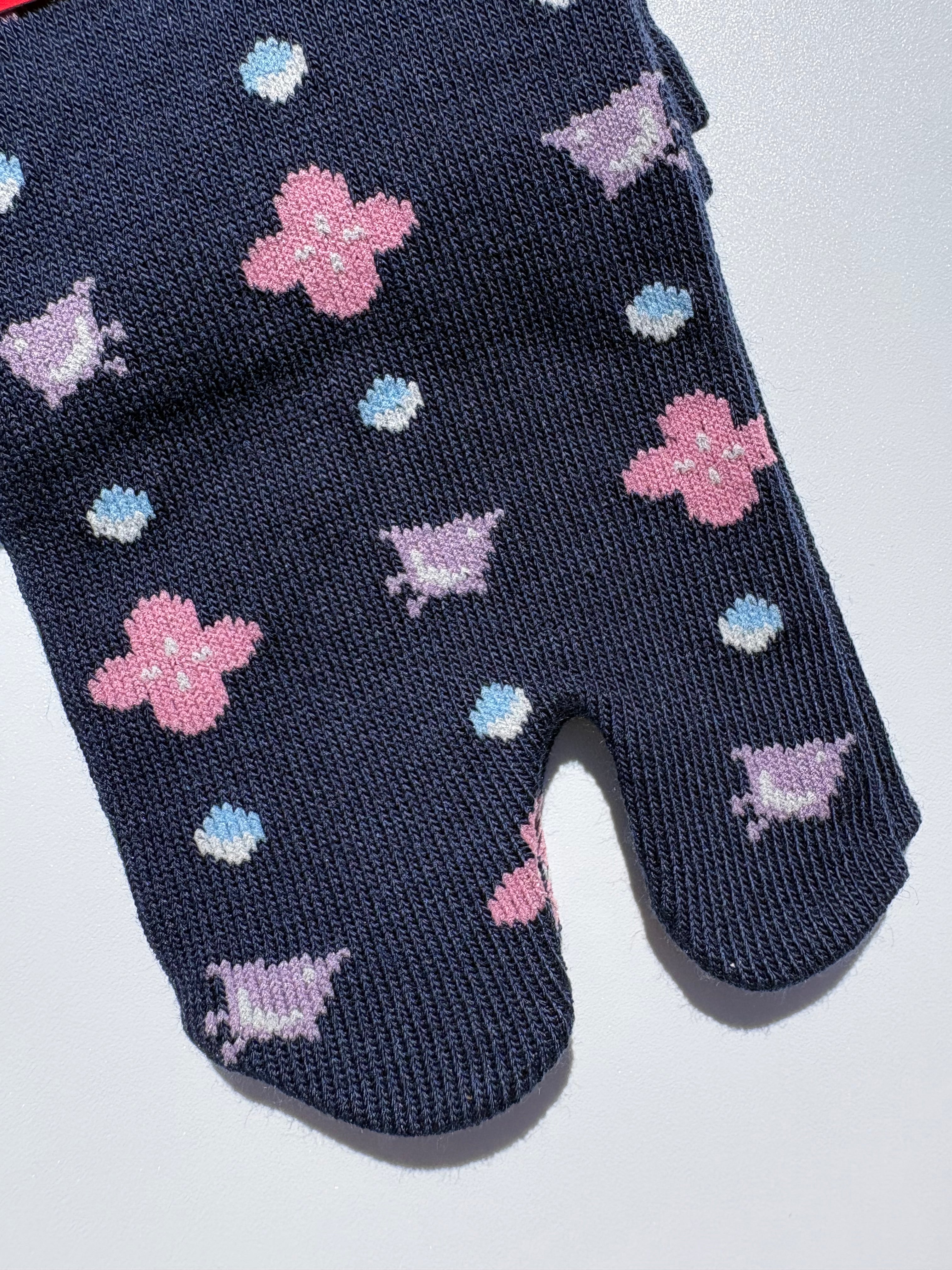 close up of navy bird print tabi socks - japanese split toe design made of cotton - flat lay on white background made in japan
