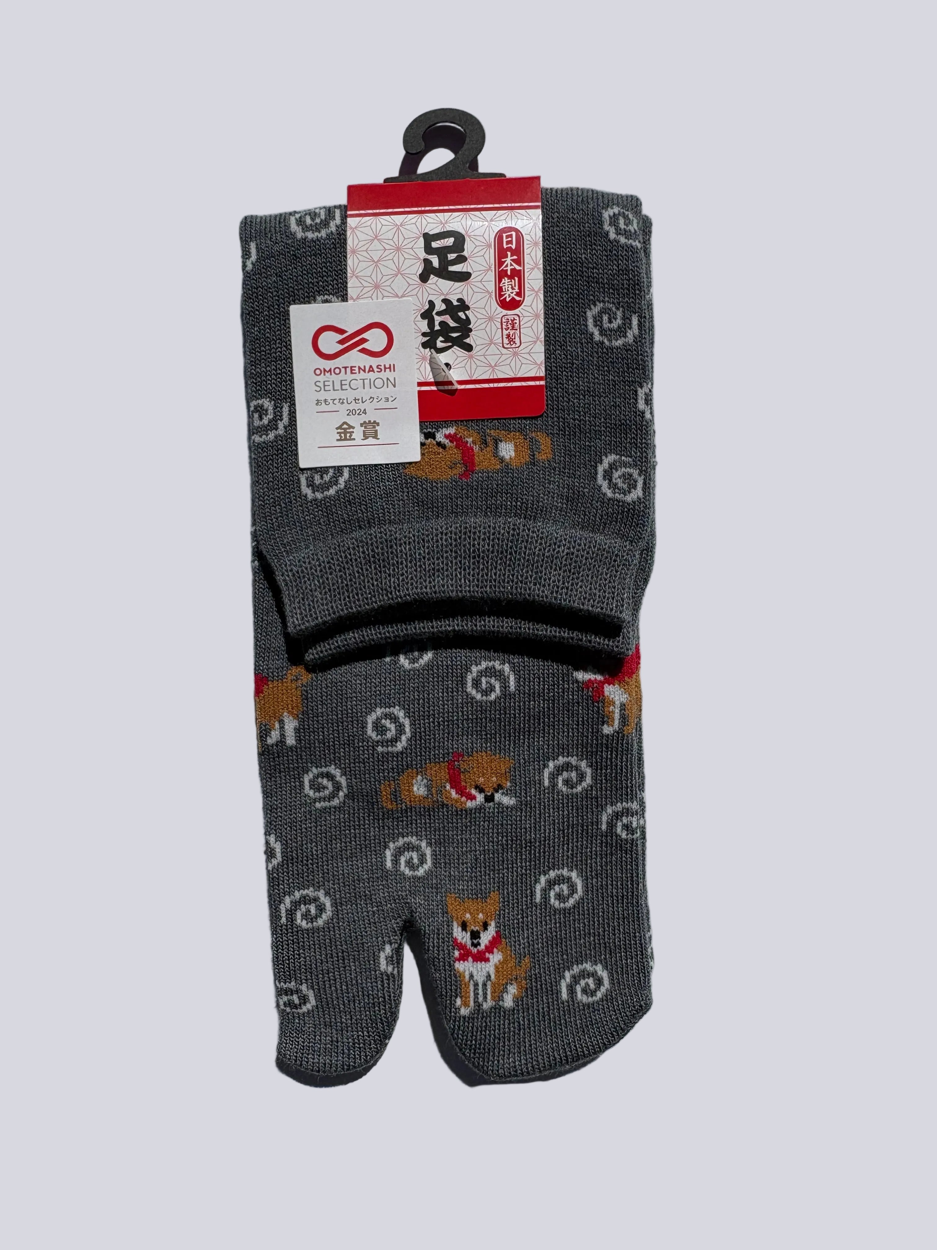 stylish pair of grey tabi socks with shiba inu dog pattern on a white background