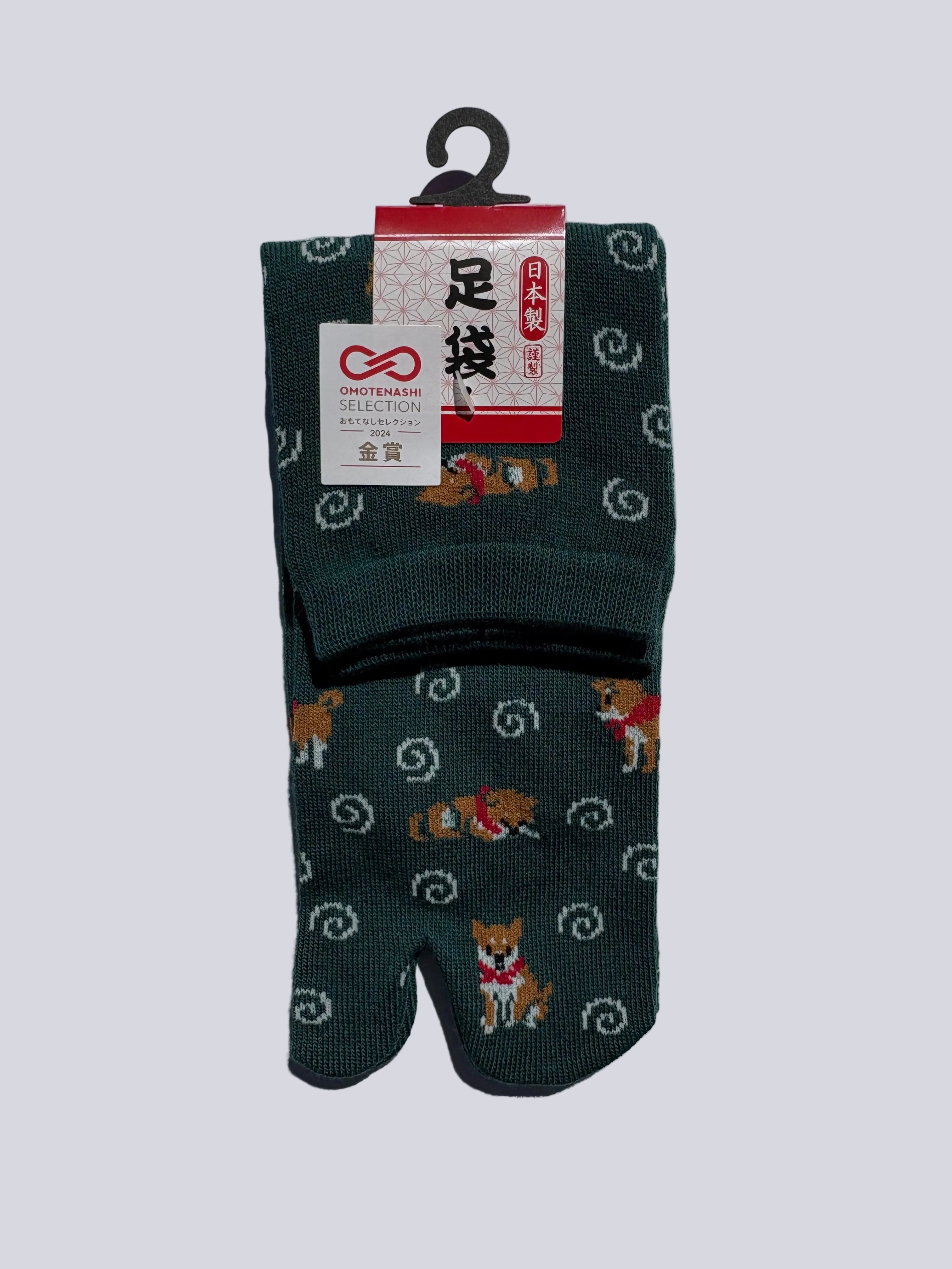stylish pair of green tabi socks with shiba inu dog pattern on a white background
