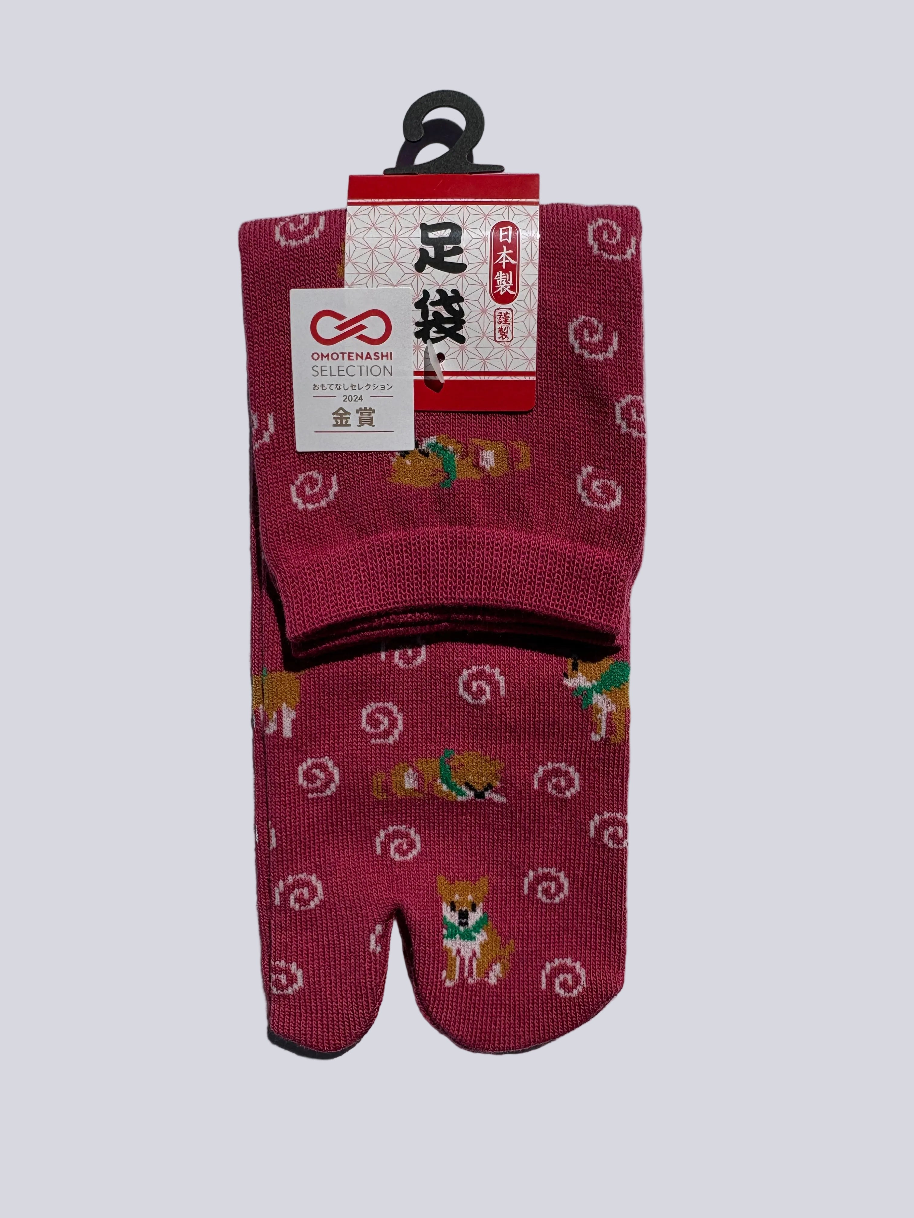 stylish pair of red tabi socks with shiba inu dog pattern on a white background