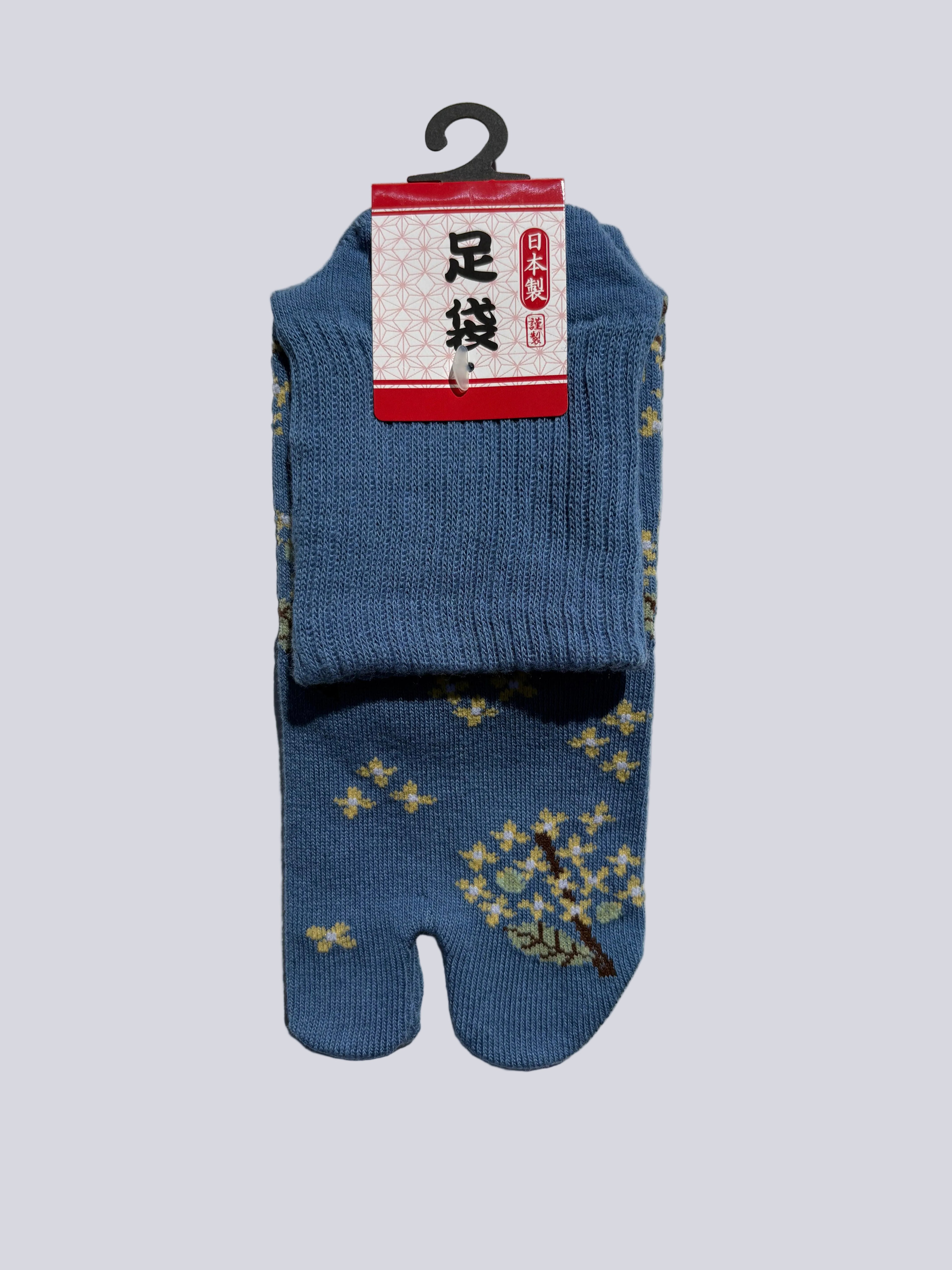 Blue tabi socks with floral pattern on a light gray background made in japan