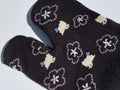 close up of black bird and sukra flower print tabi socks