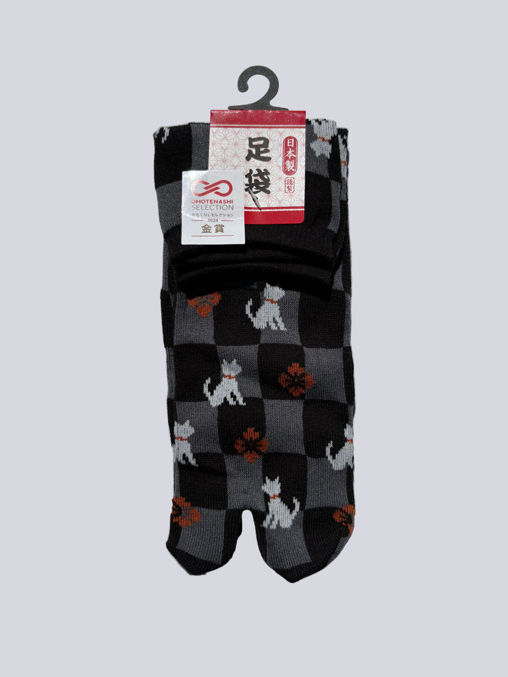 Pair of black checkered socks with white dog pattern on a gray background