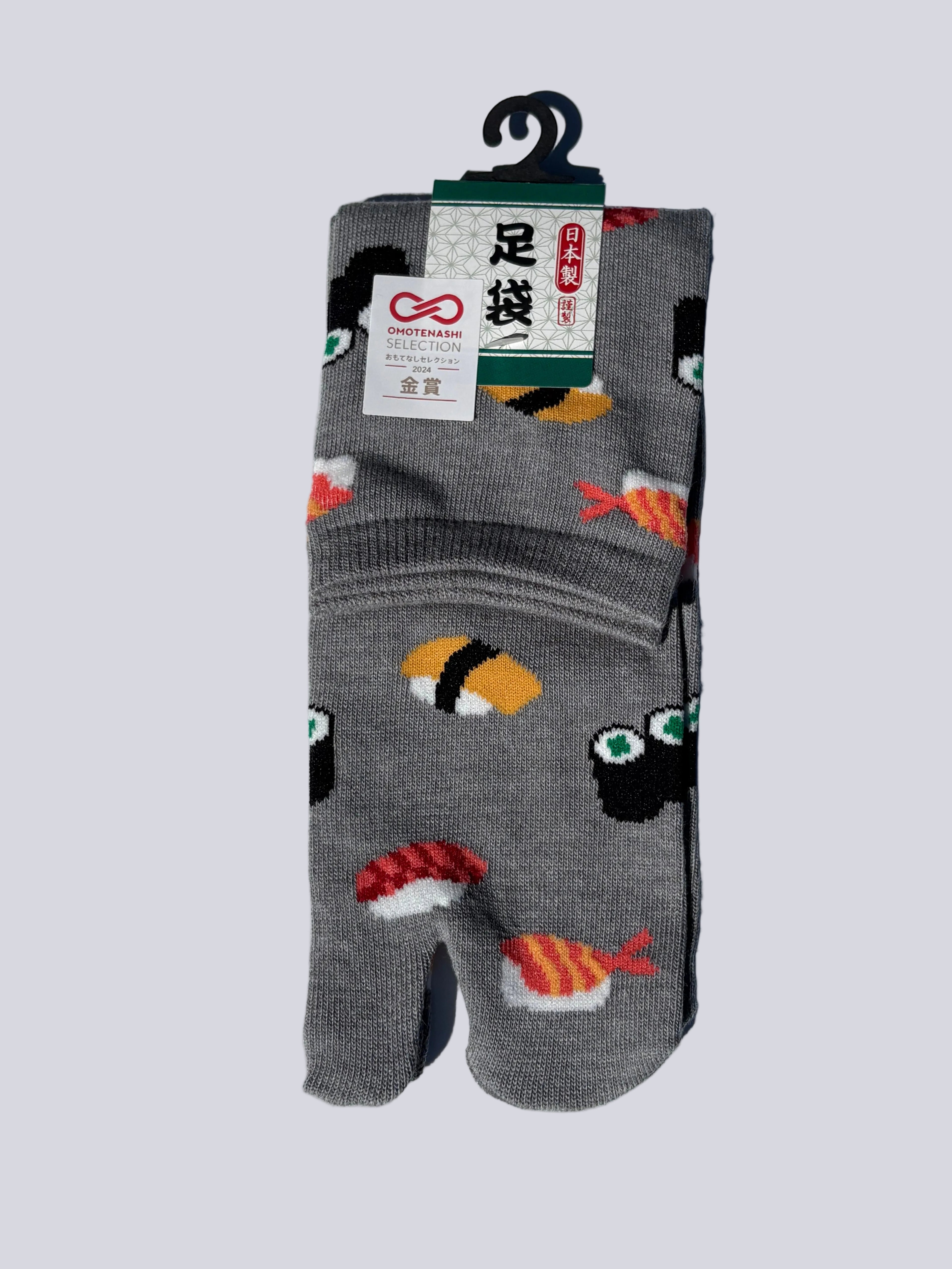 Pack of grey japanese cotton tabi socks with sushi print design on a white background flat lay