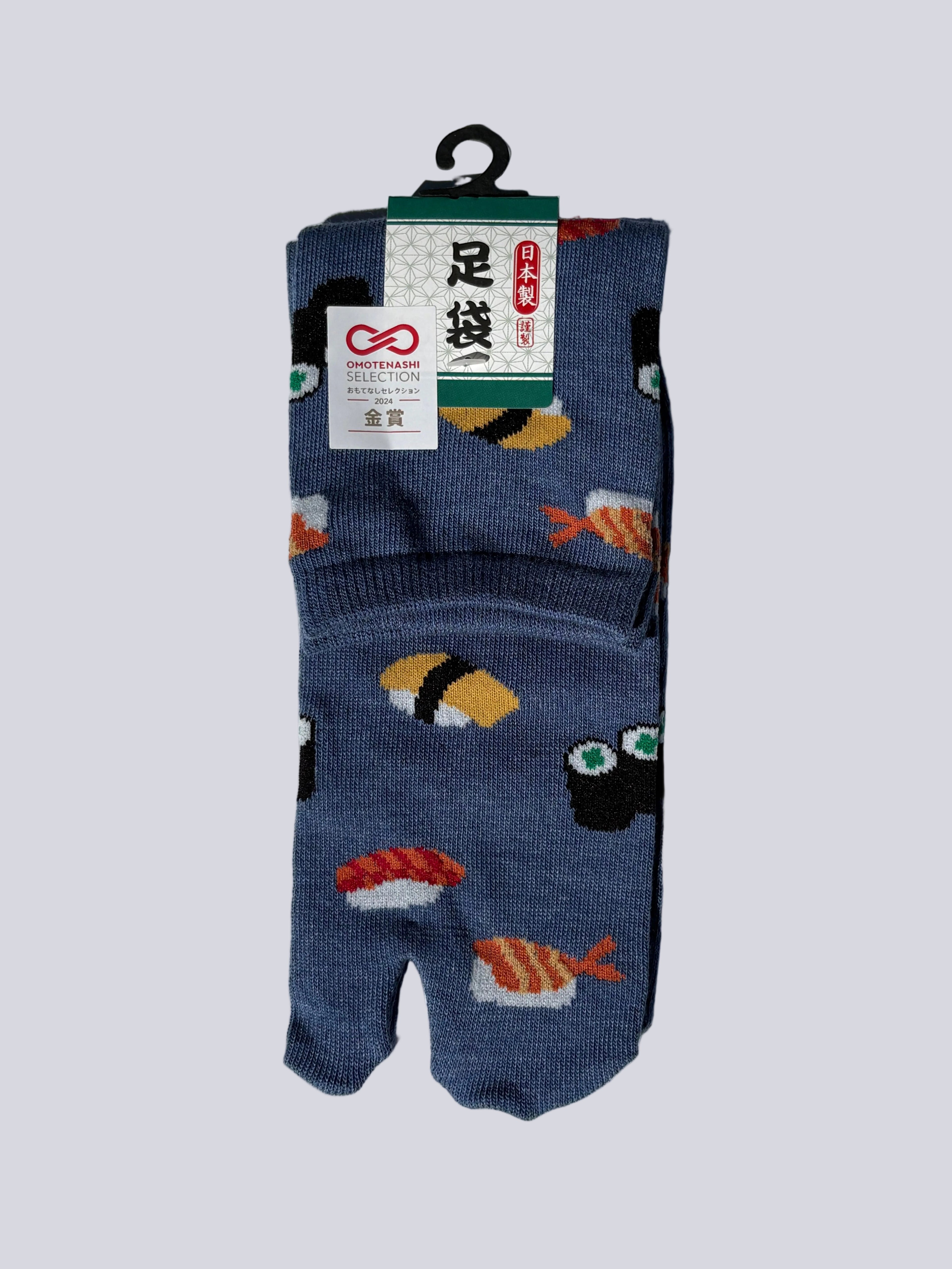 Pack of blue japanese cotton tabi socks with sushi print design on a white background flat lay