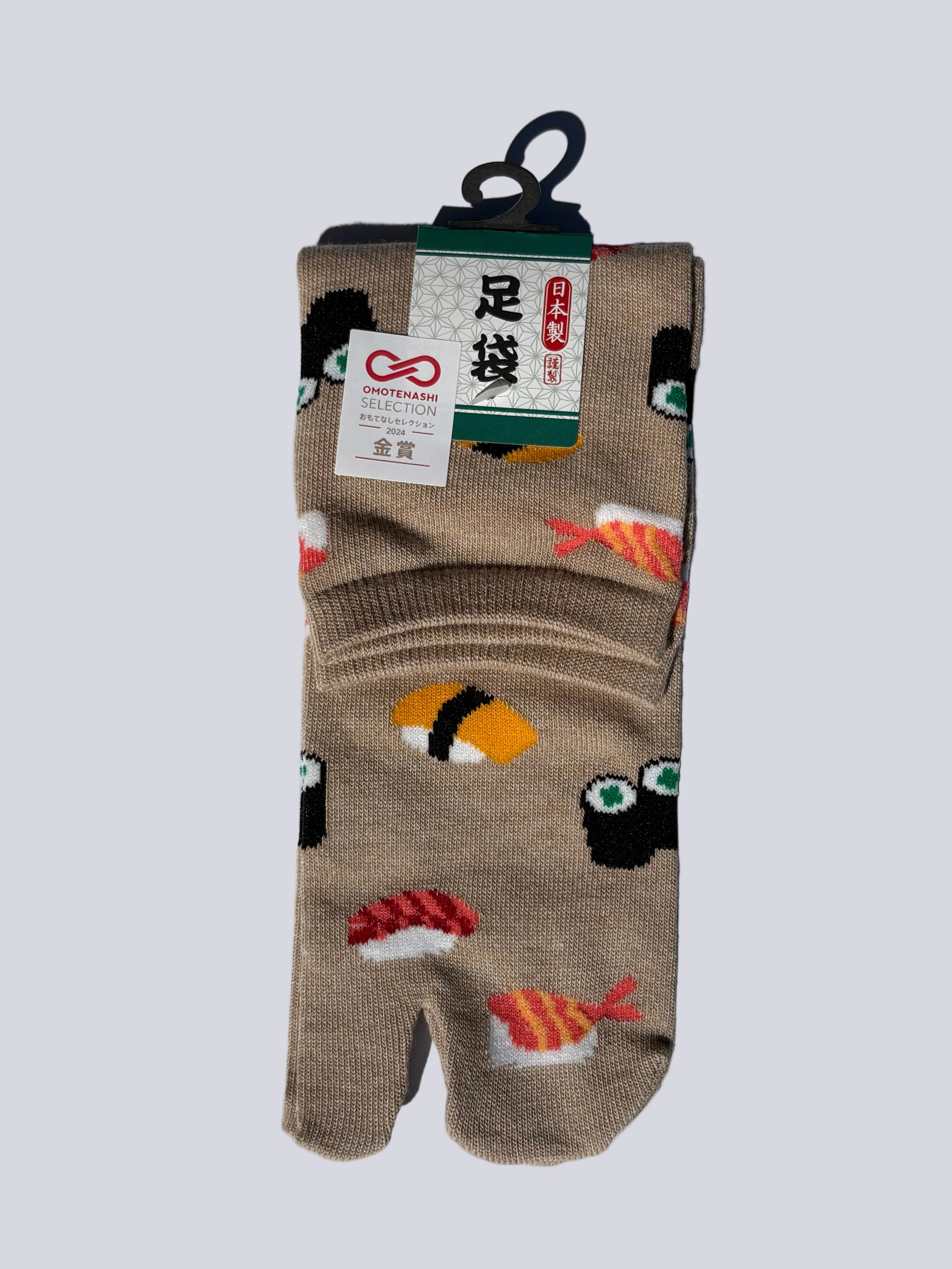 Pack of beige japanese cotton tabi socks with sushi print design on a white background flat lay