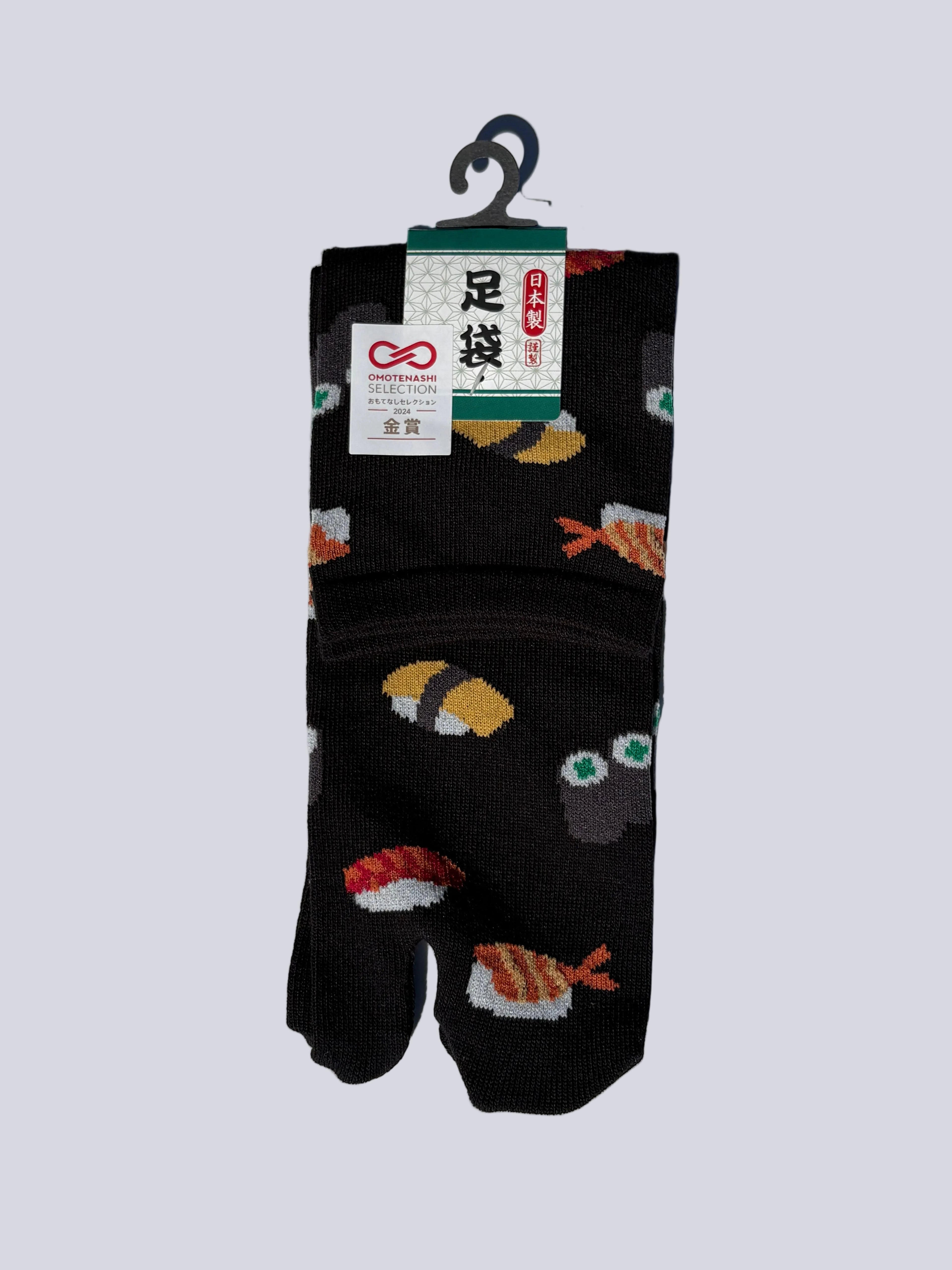 Pack of black japanese cotton tabi socks with sushi print design on a white background flat lay