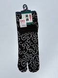 black tabi split-toe socks with white karakusa arabesque scroll pattern — Omotenashi Selection Gold Award 2024 Japanese-made tabi socks (足袋)