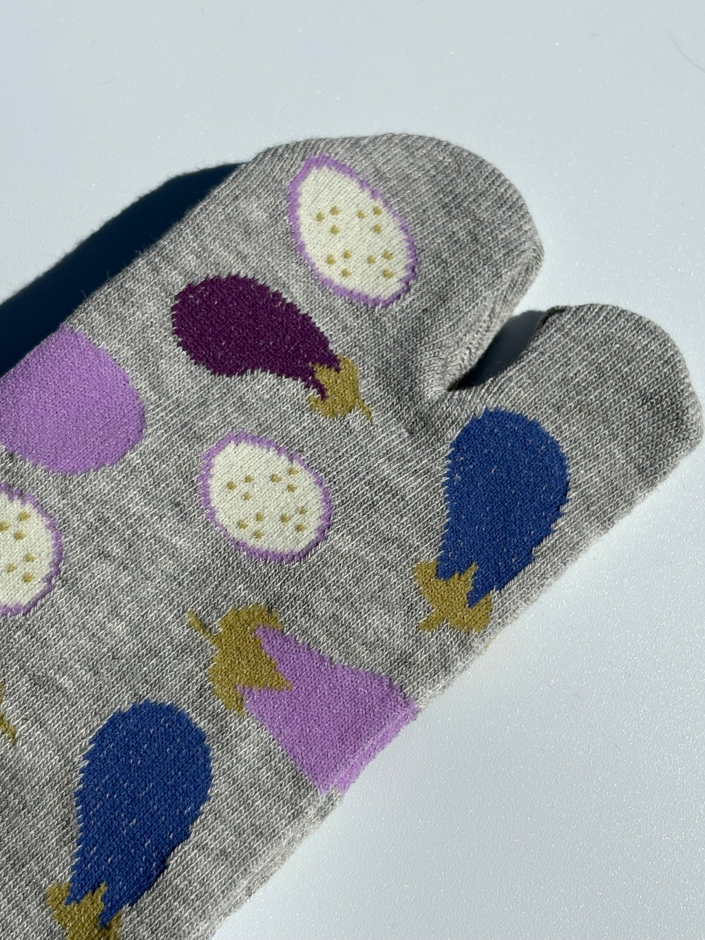 close up of grey Japanese tabi split-toe socks with aubergine and eggplant vegetable print  — soft elastic relaxed-fit tabi socks made in Japan