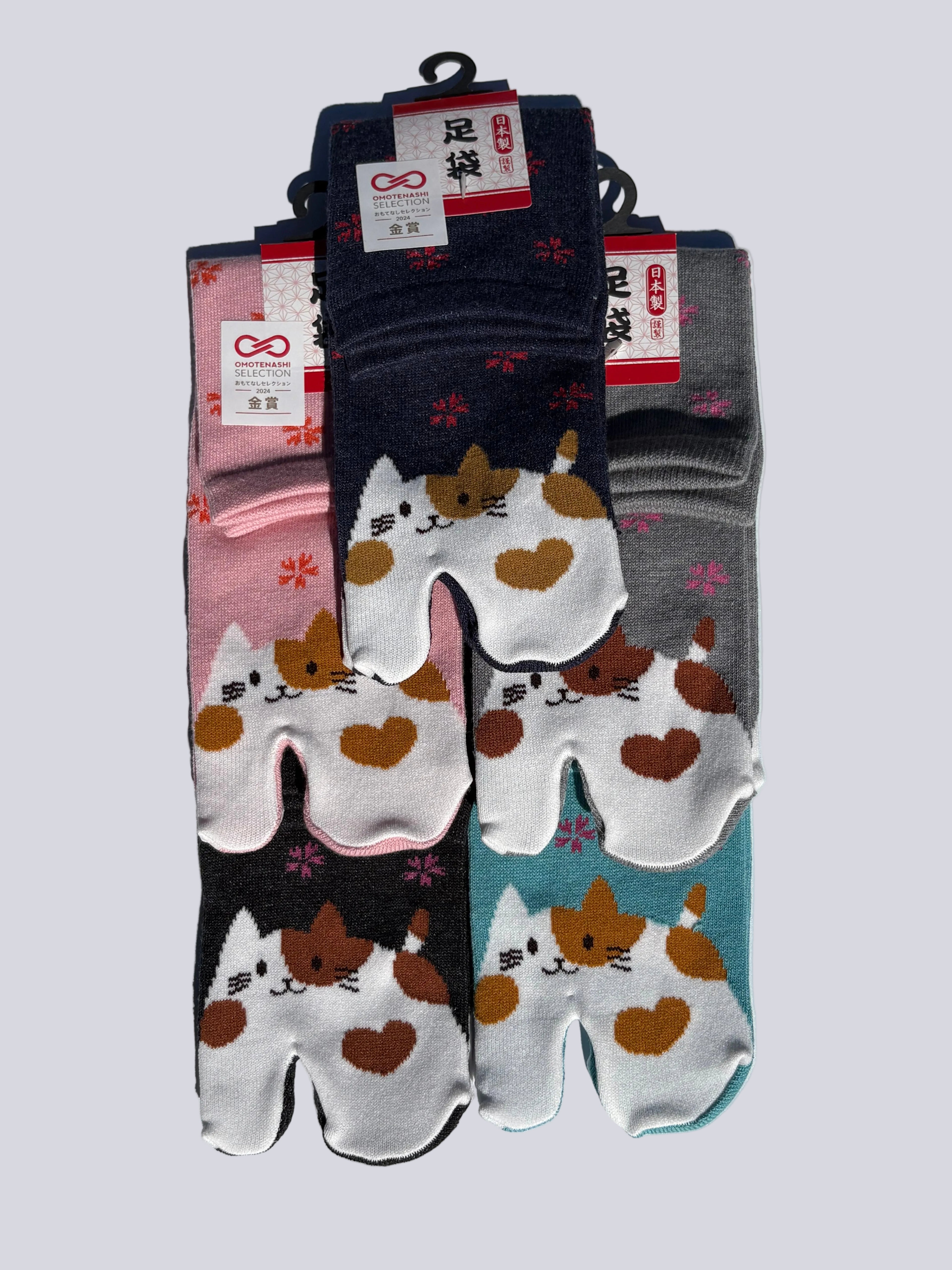 Five pairs of tabi split-toe socks with calico cat print in pink, navy, teal, black, and grey — Omotenashi Selection Gold Award Japanese cat novelty tabi socks (足袋)
