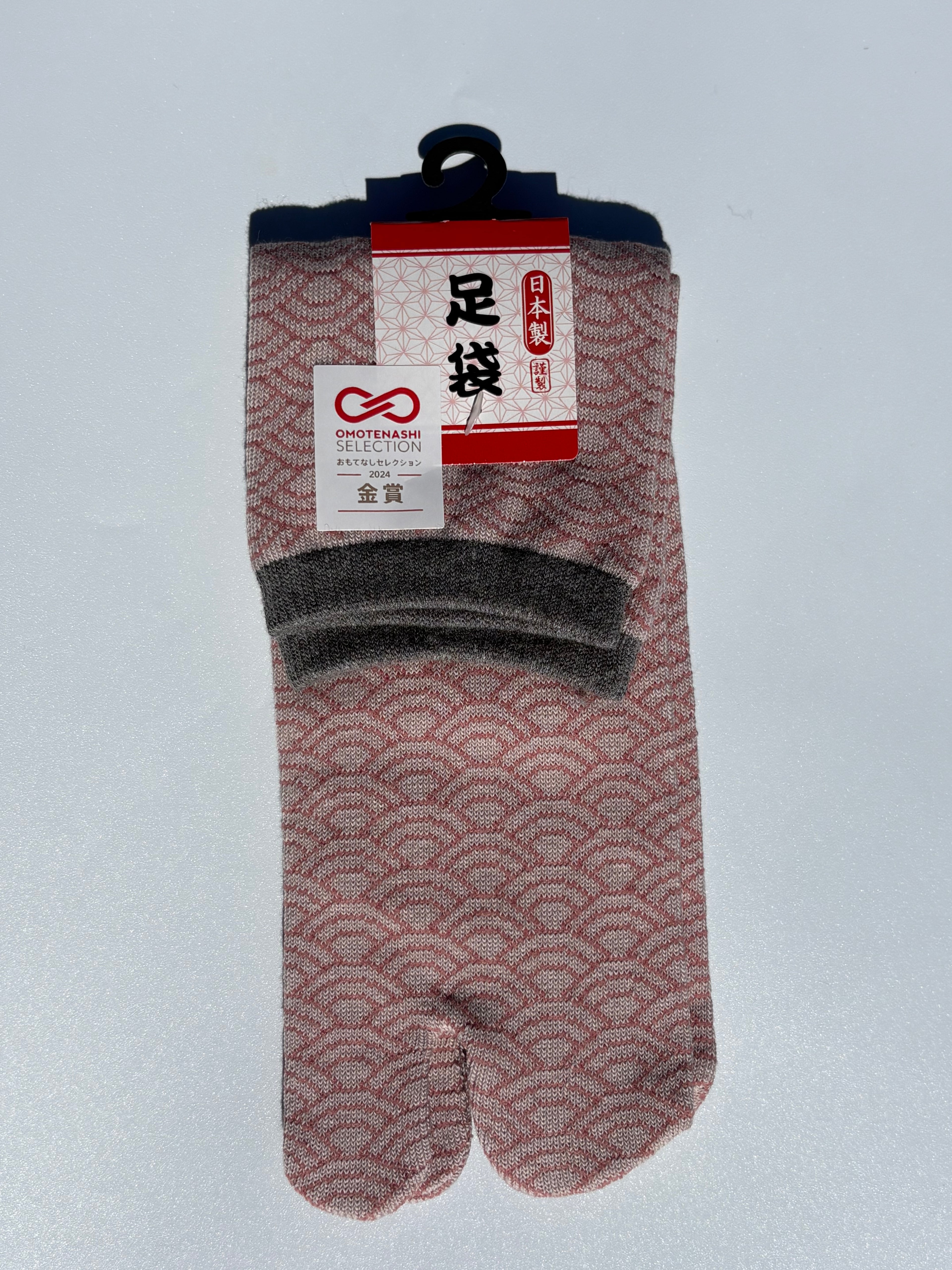 Pair of seigeiha print tabi socks with a pattern on a light gray background