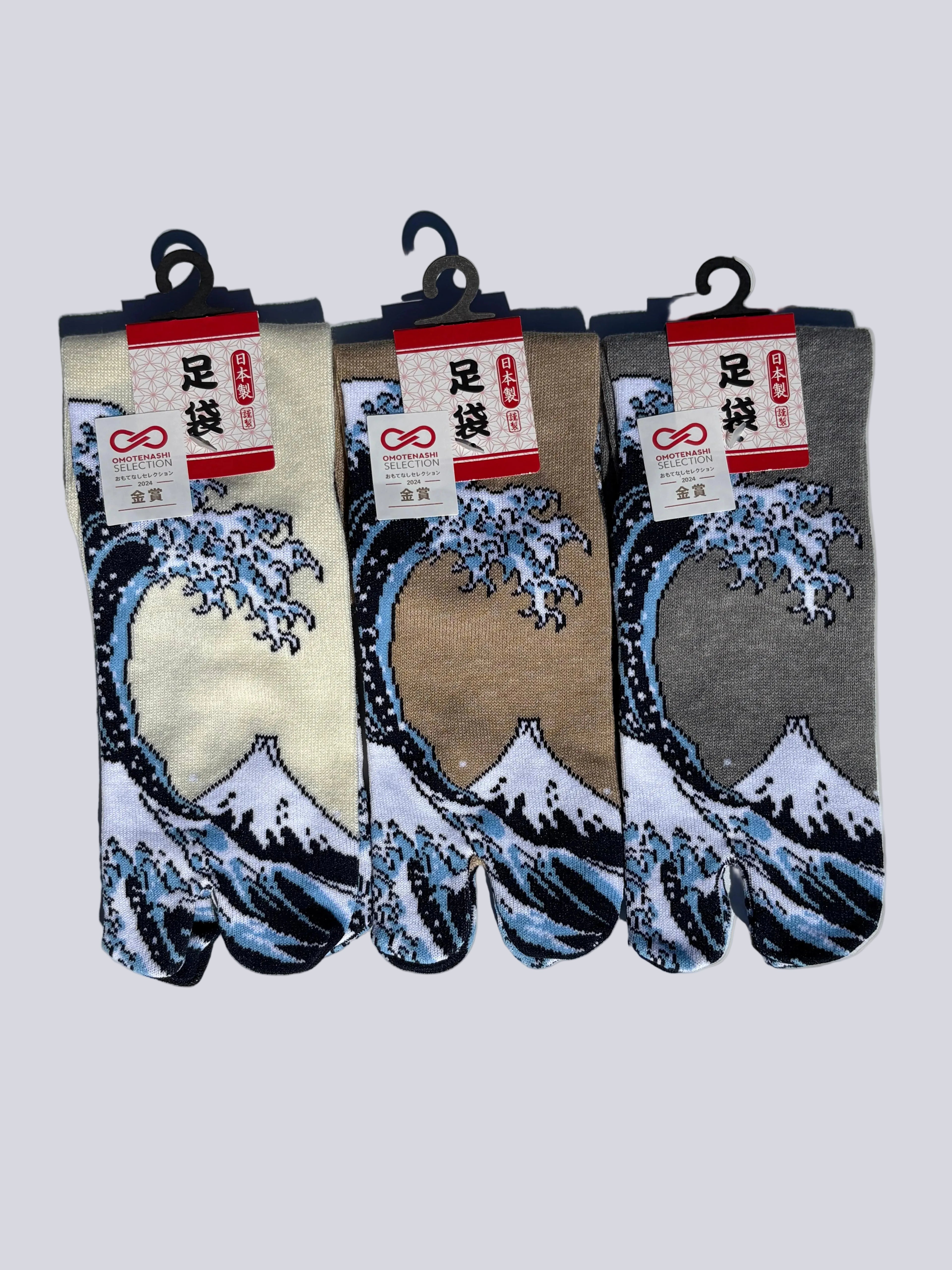 Three pairs of tabi split-toe socks with Hokusai Great Wave print in cream, taupe, and grey colourways — Omotenashi Selection Gold Award 2024 Japanese art tabi socks (足袋)