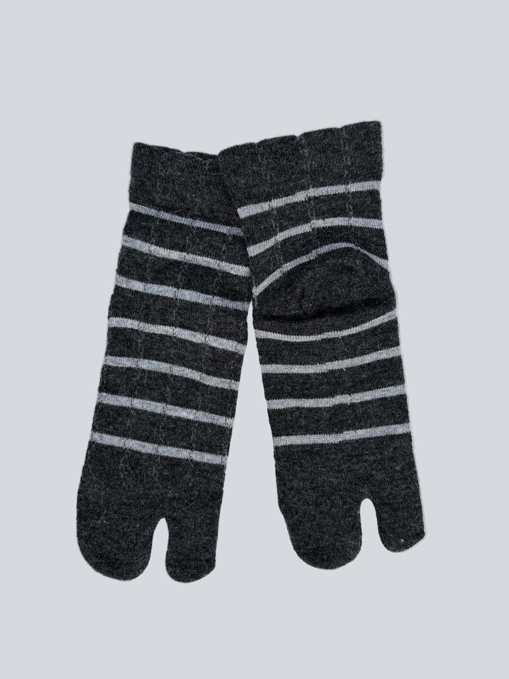 Flat lay  of  angora wool blend ankle length grey wool warm knit Japanese tabi socks super soft luxury premium quality striped dark grey and white on a white background