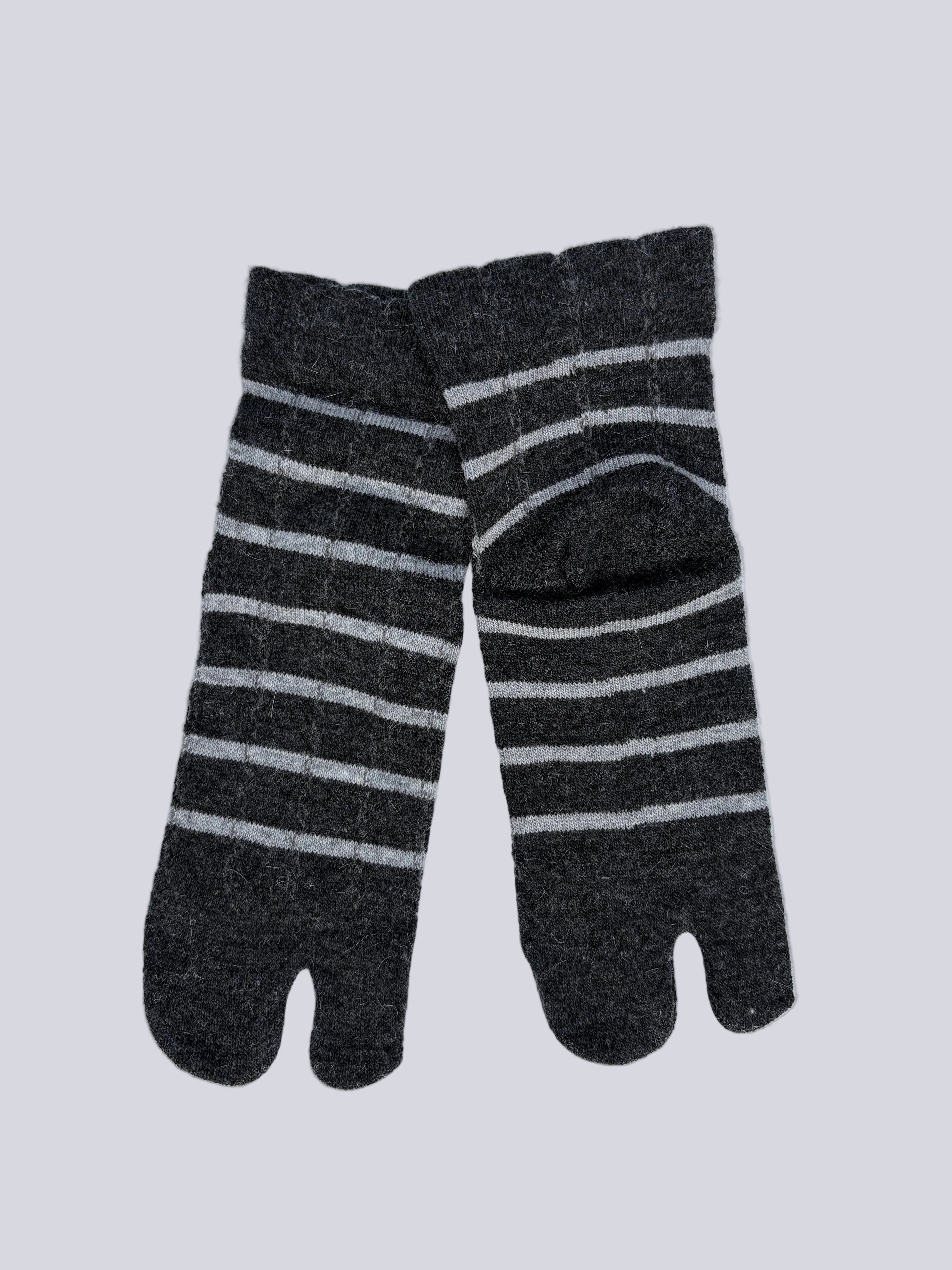 Flat lay  of  angora wool blend ankle length grey wool warm knit Japanese tabi socks super soft luxury premium quality striped dark grey and white on a white background
