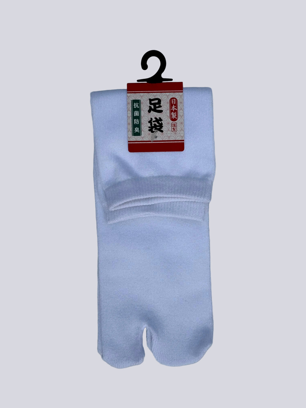 Classic premium White tabi socks with a red and white label on a light gray background - made in japan cotton texture