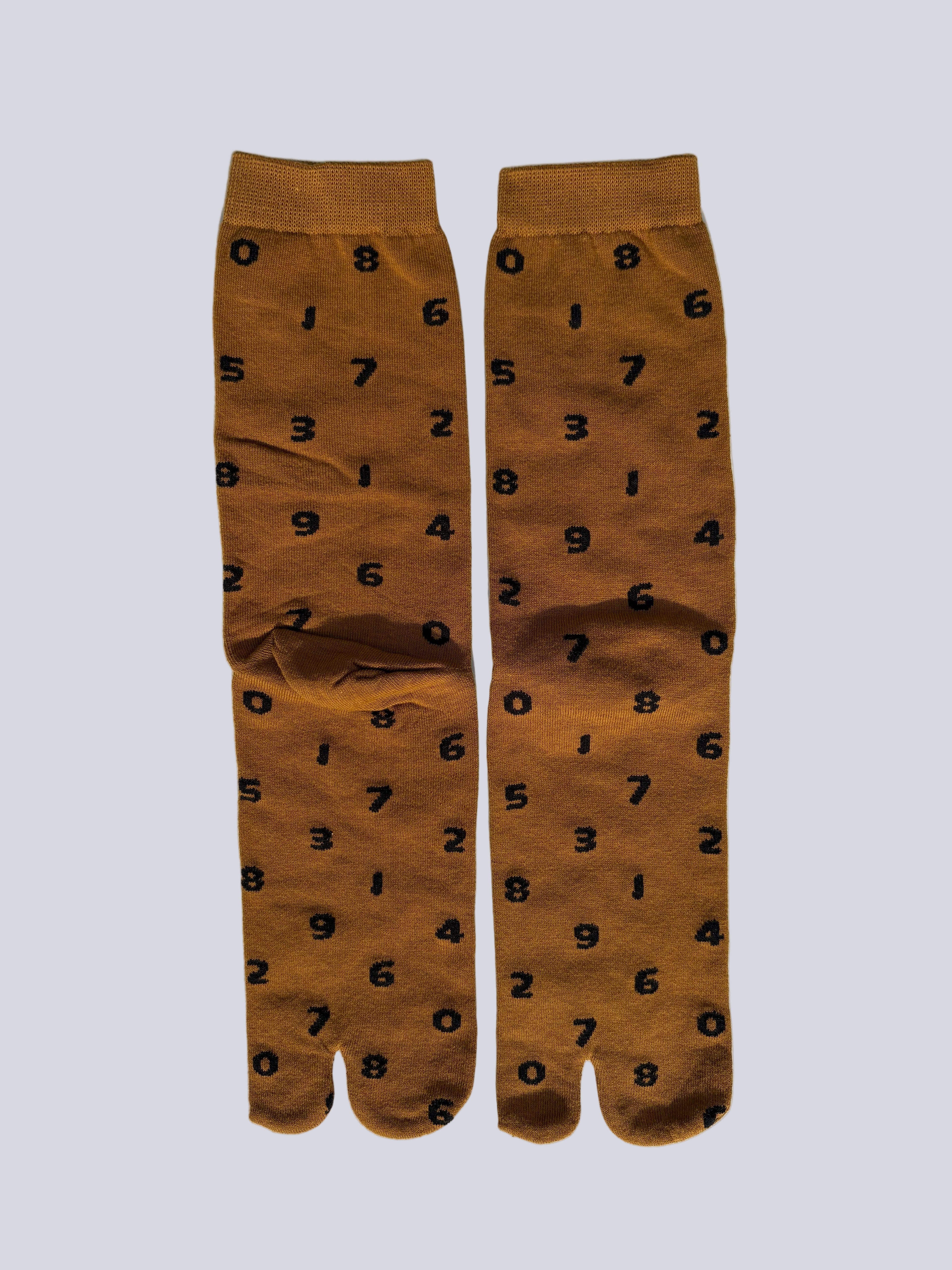 tabi split-toe socks flat lay— tan with black numbers— novelty Japanese split-toe socks made of cotton