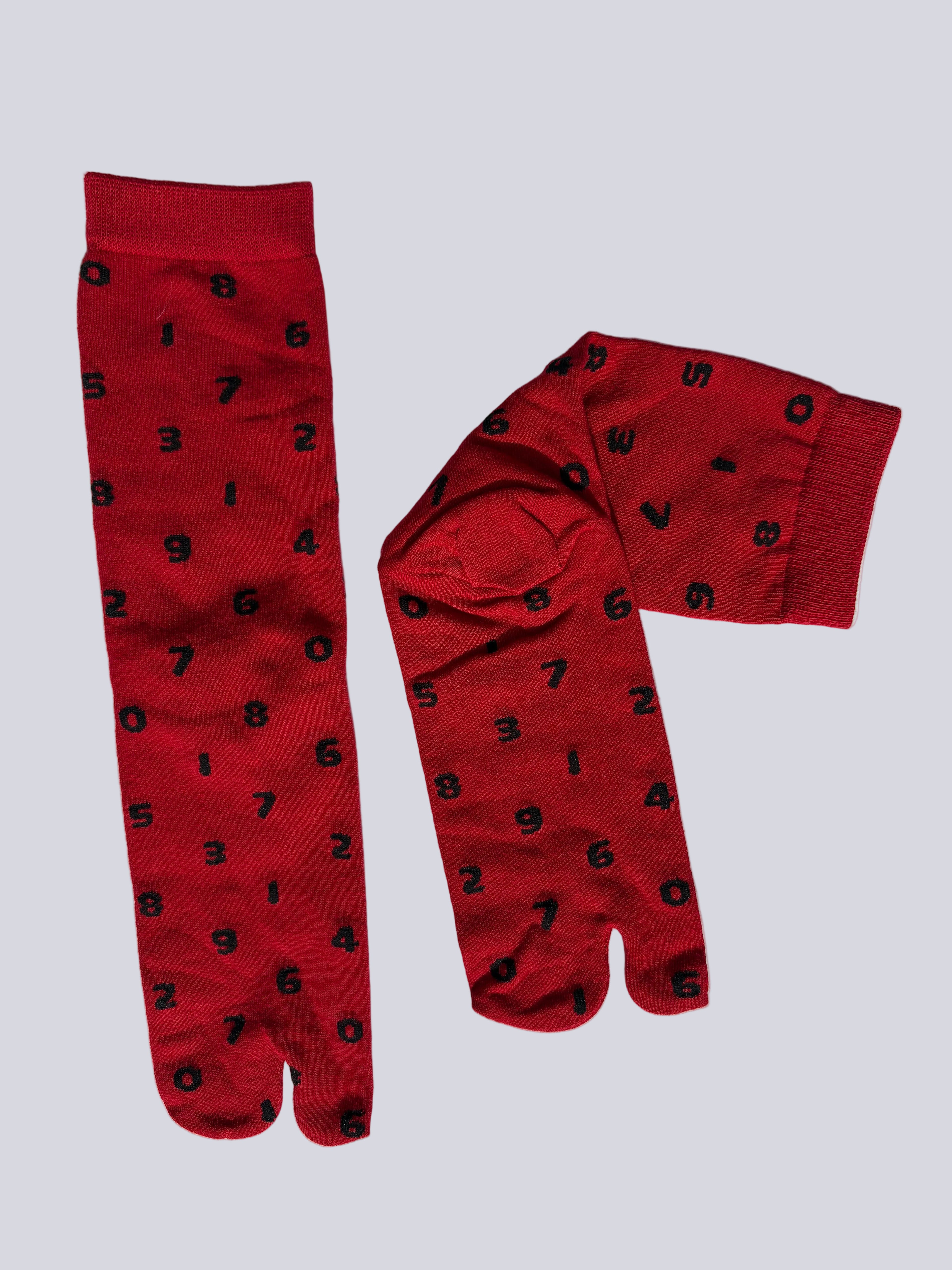 Red tabi socks with black patterns on a white background made of cotton japanese split toe design