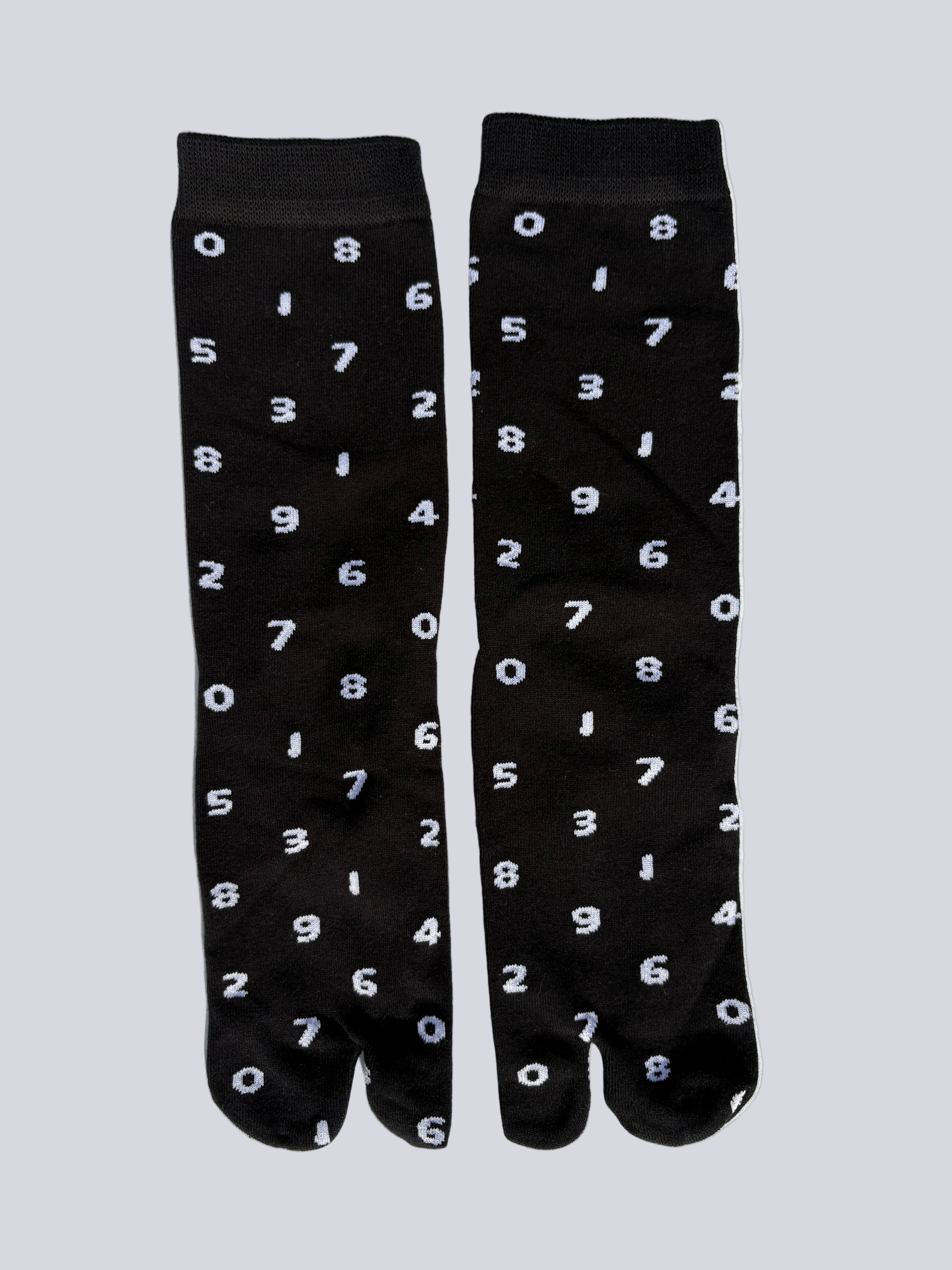tabi split-toe socks flat lay—black cotton with white numbers — novelty Japanese split-toe socks crew length