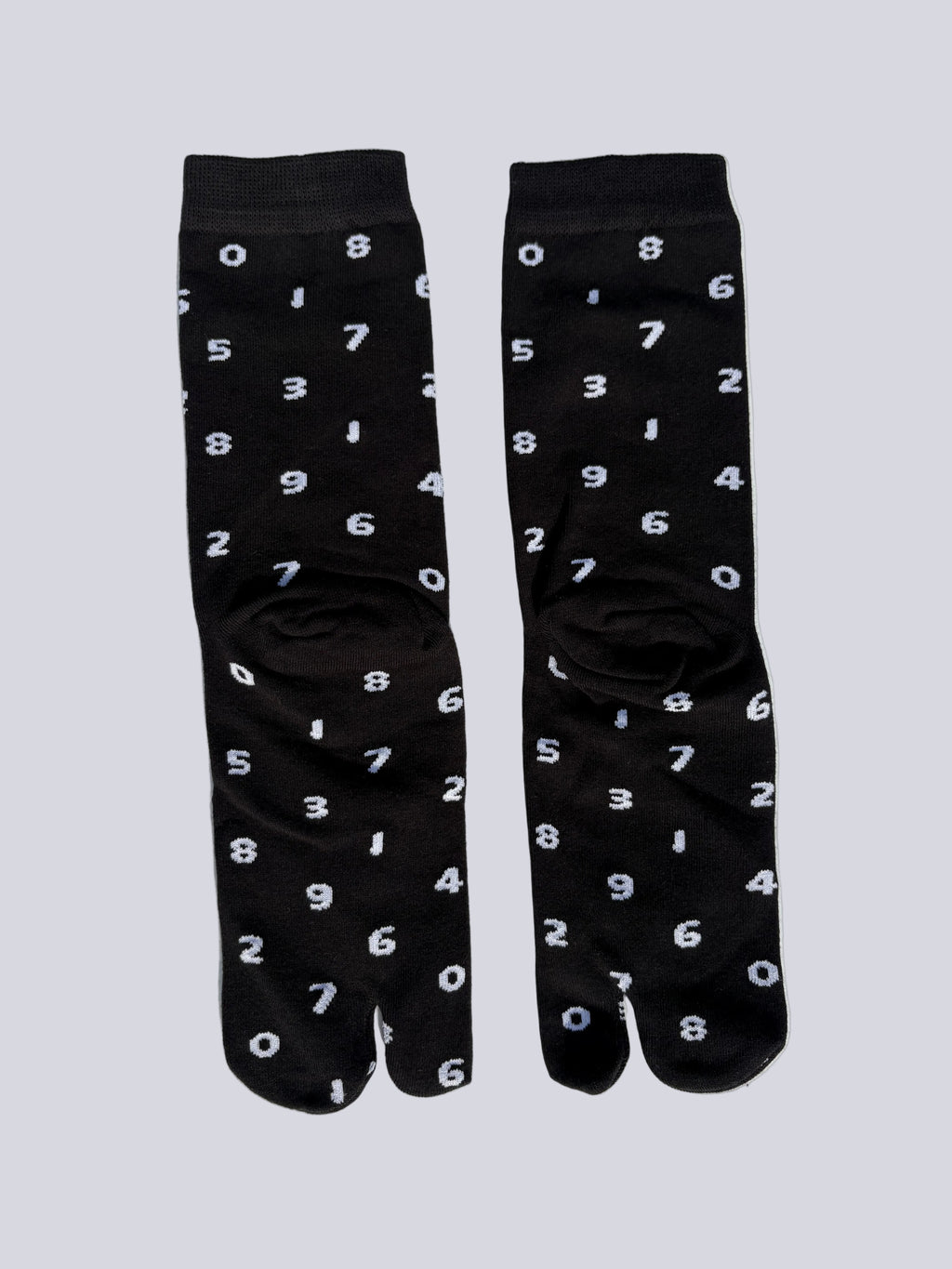 tabi split-toe socks flat lay—black cotton with white numbers — novelty Japanese split-toe socks crew length