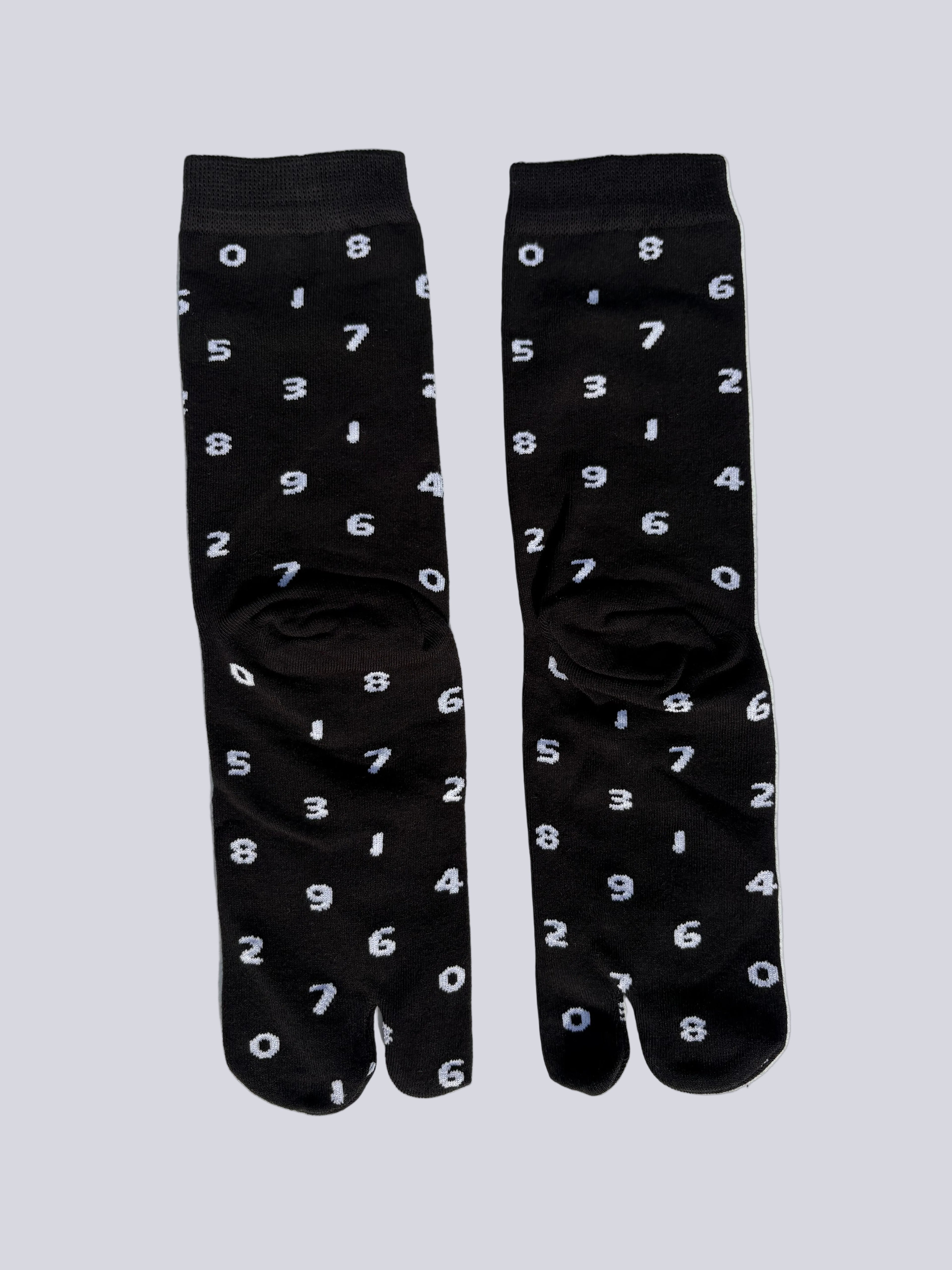 tabi split-toe socks flat lay—black cotton with white numbers — novelty Japanese split-toe socks crew length