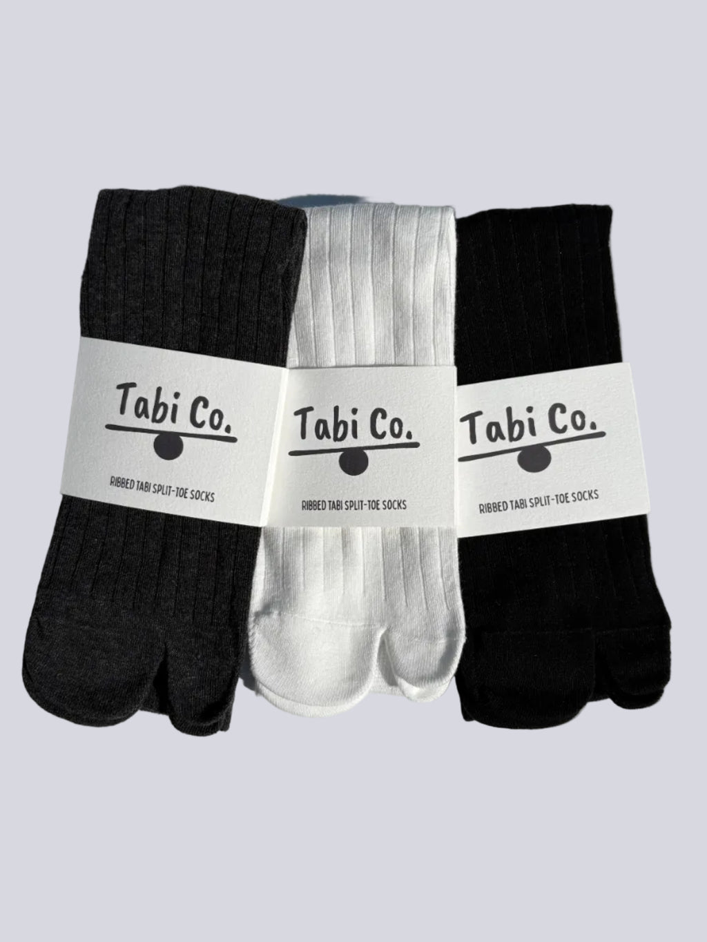 Tabi Co. ribbed tabi split-toe socks in black, white, and charcoal grey — three-pack Japanese tabi socks with branded packaging