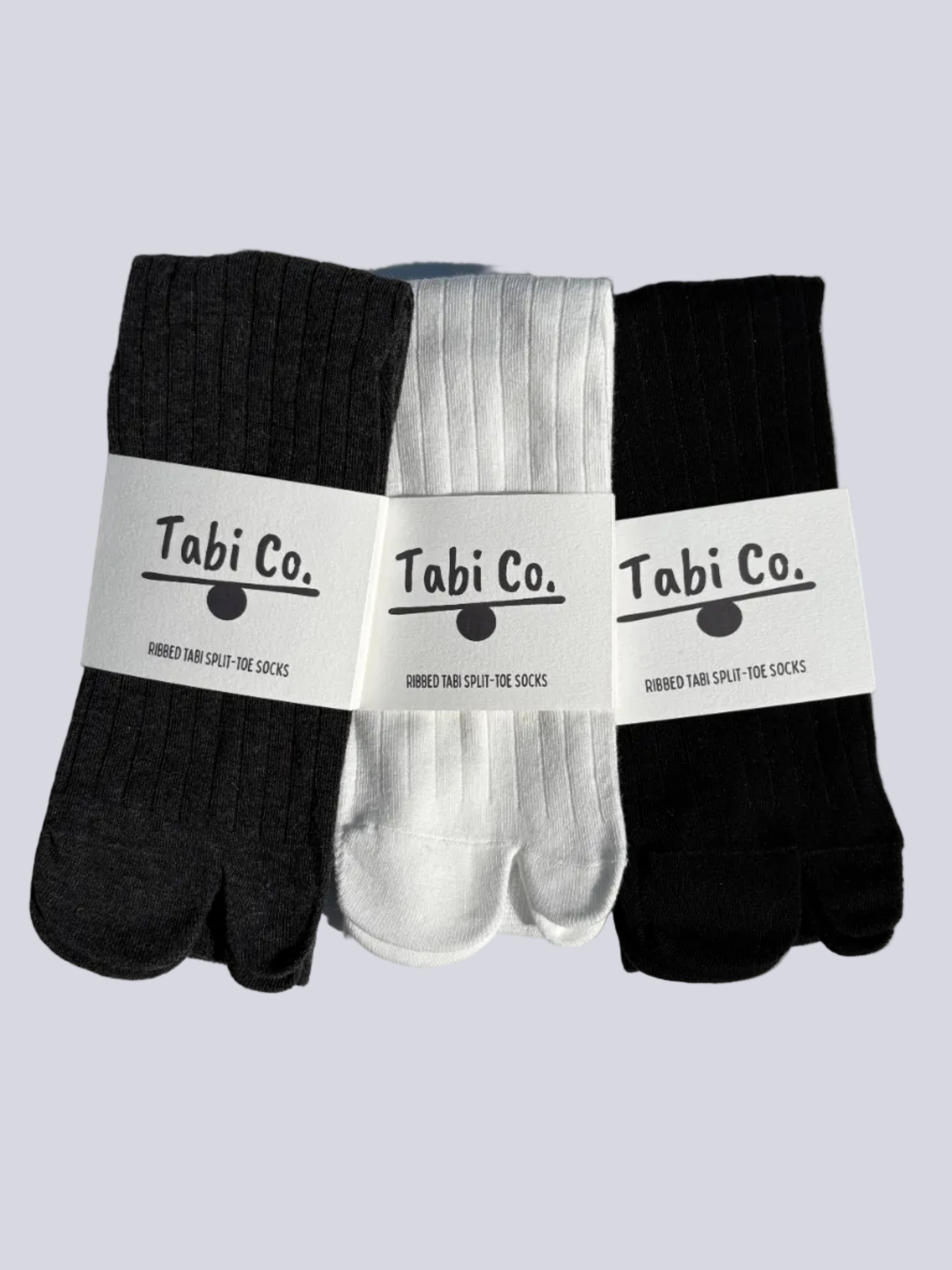 Tabi Co. ribbed tabi split-toe socks in black, white, and charcoal grey — three-pack Japanese tabi socks with branded packaging