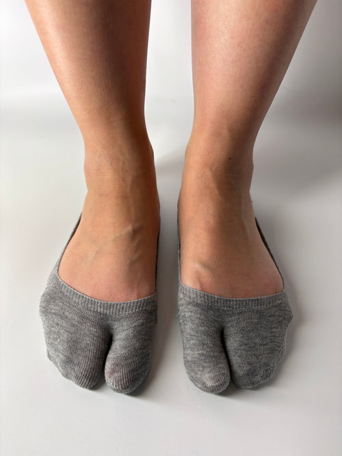 grey ankle split toe socks worn by a person on a white background