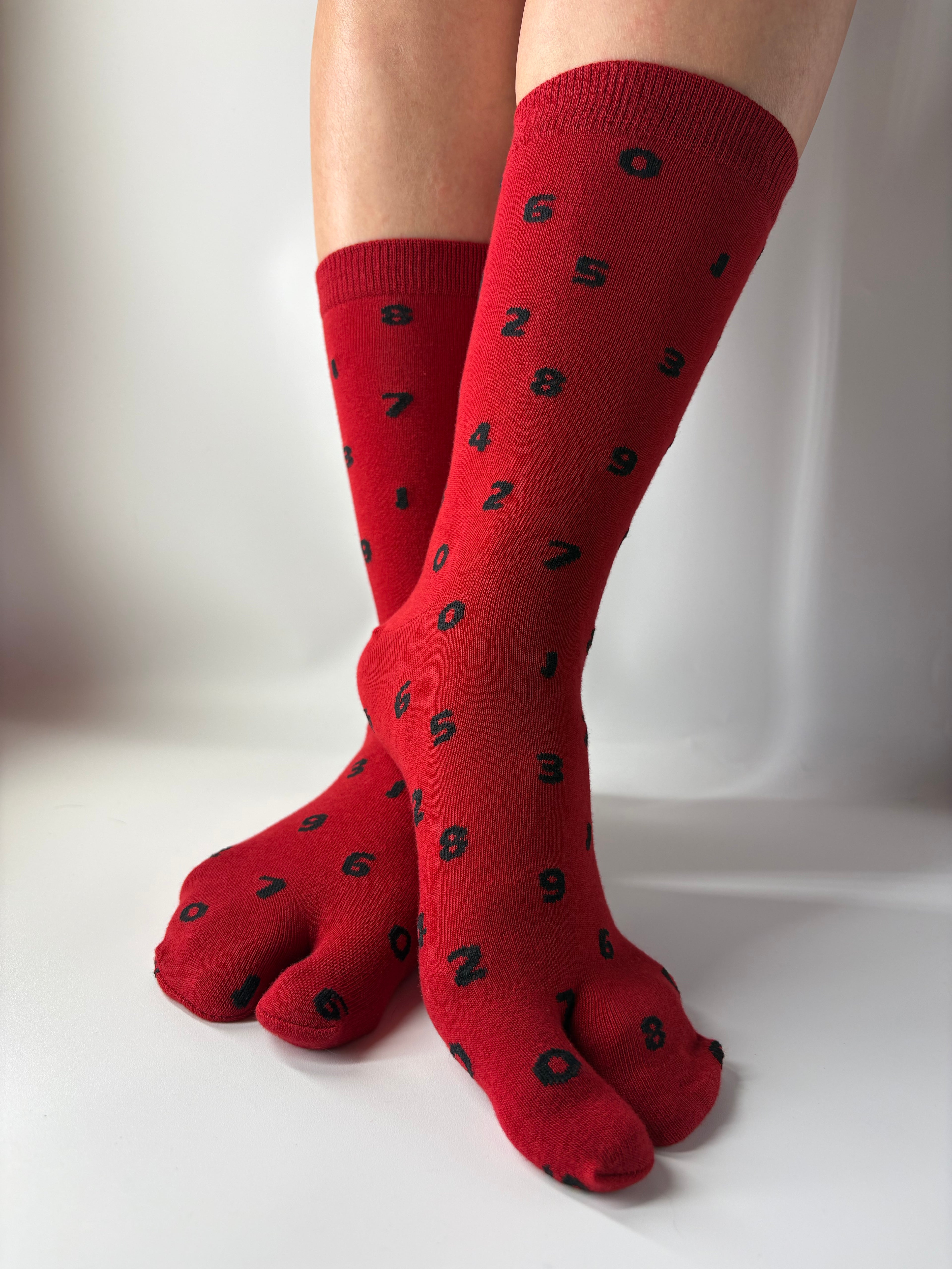 Red socks with black numbers on a white background