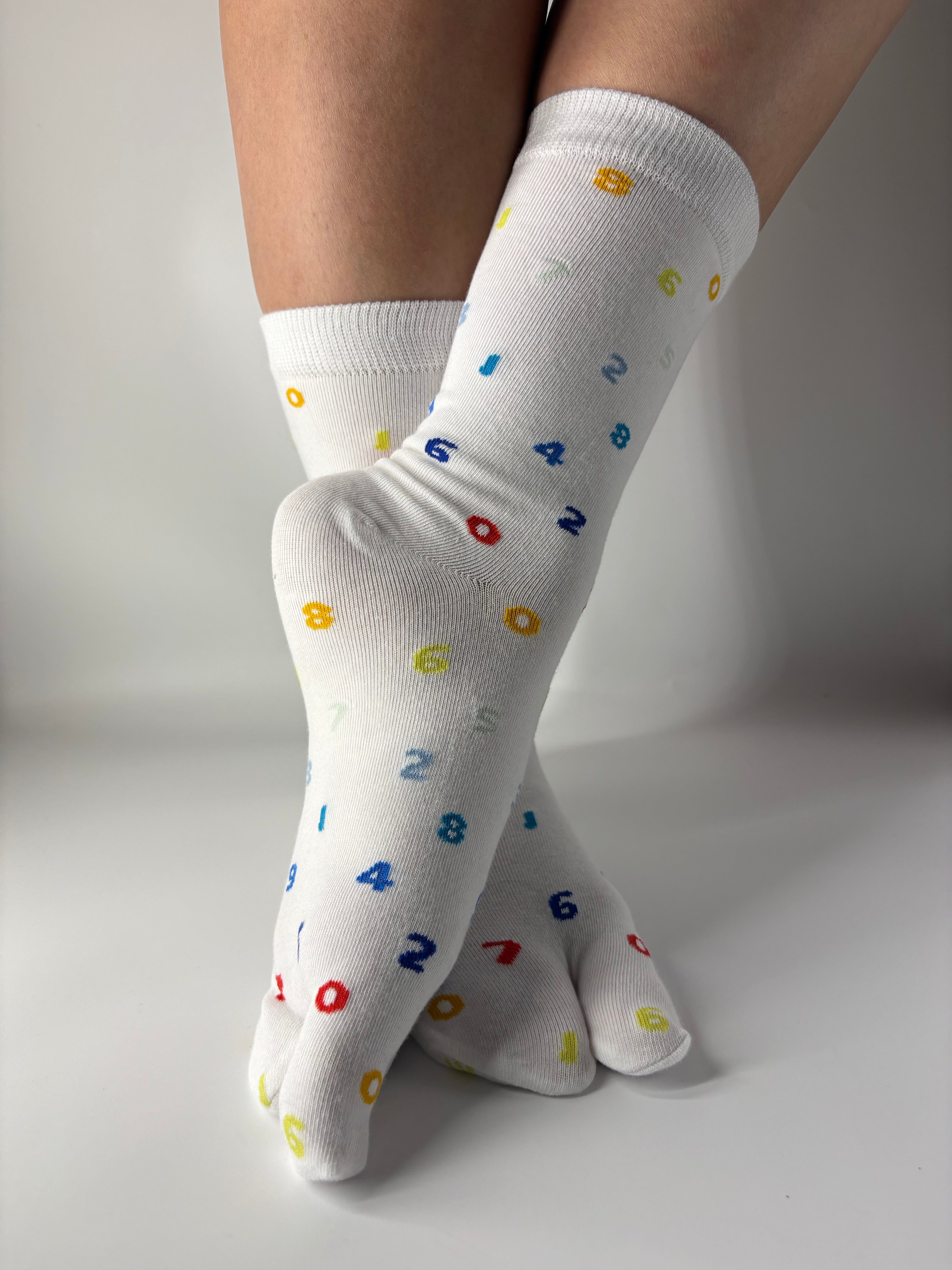 White crew-length tabi socks with a playful all-over multicoloured numbers print