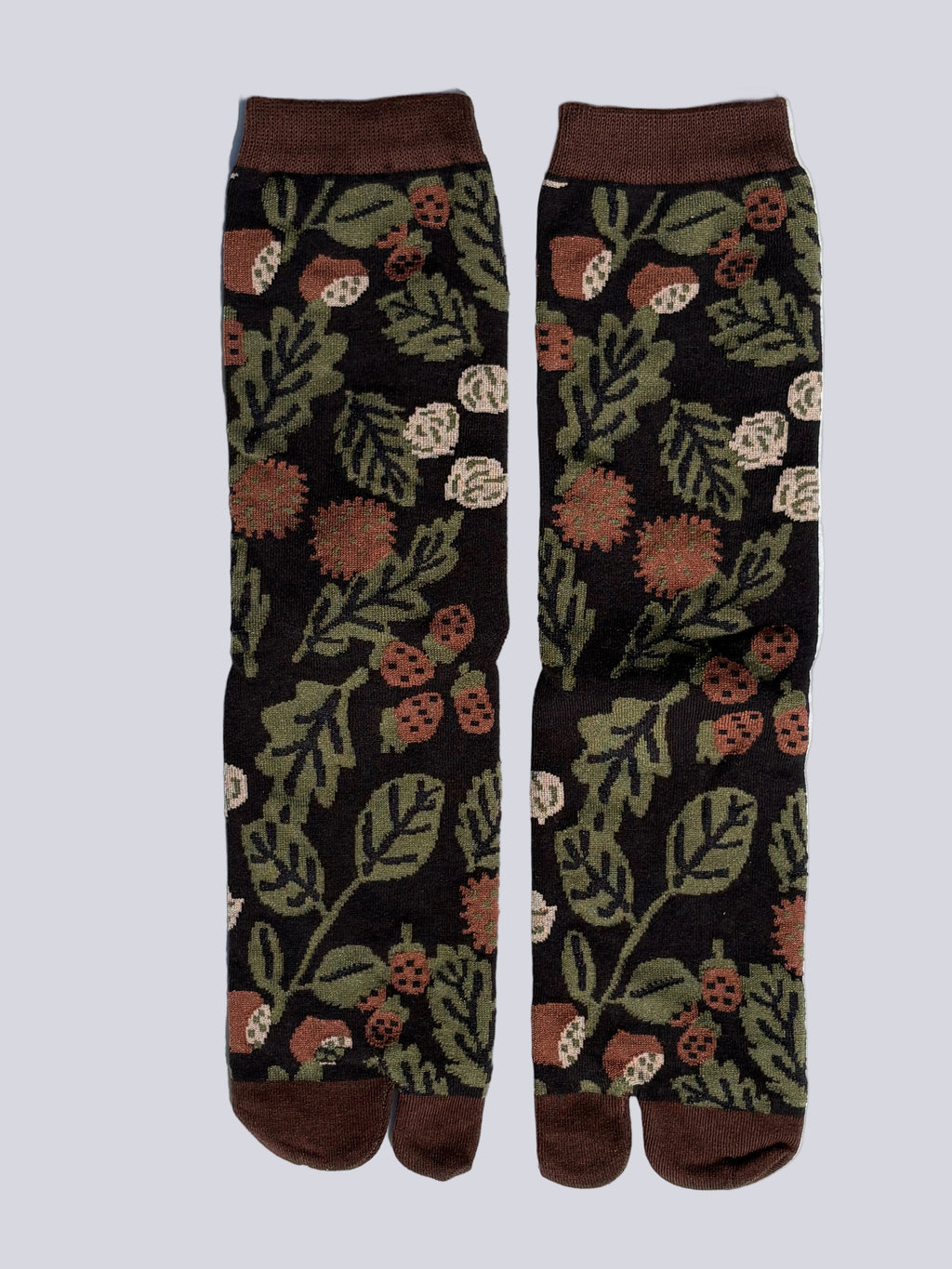 Black tabi split-toe socks with allover botanical print featuring acorns, berries, and green leaves — Japanese tabi socks with nature-inspired autumn design