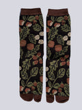 Black tabi split-toe socks with allover botanical print featuring acorns, berries, and green leaves — Japanese tabi socks with nature-inspired autumn design